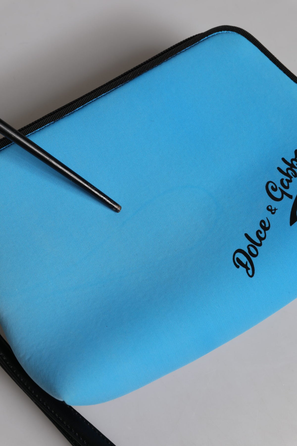 Indulge in the exquisite Dolce & Gabbana Blue DG Logo Print Clutch, a luxurious blend of nylon and spandex, embodying timeless elegance for the discerning individual.