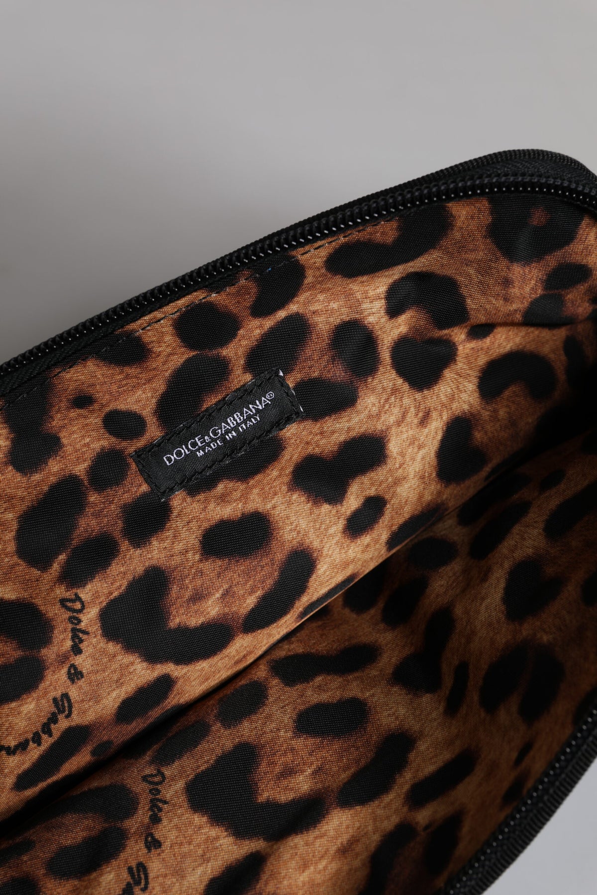 Indulge in the exquisite Dolce & Gabbana Blue DG Logo Print Clutch, a luxurious blend of nylon and spandex, crafted in Italy for those who embody elegance and sophistication.
