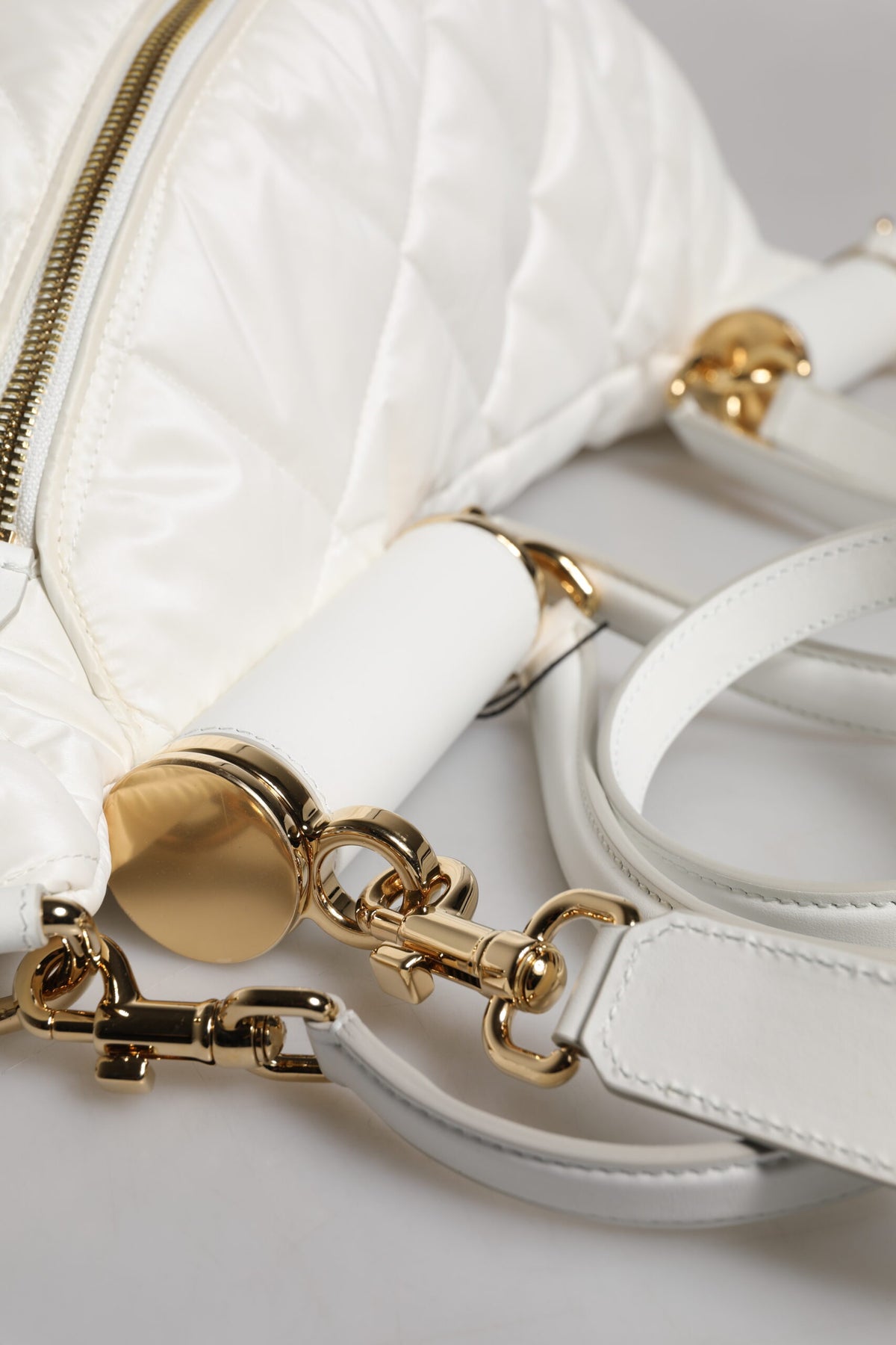 Indulge in the exquisite Dolce & Gabbana White Quilted Logo Plaque Belt Waist Fanny Pack Bag, a symbol of timeless luxury and unparalleled craftsmanship, perfect for the discerning individual.