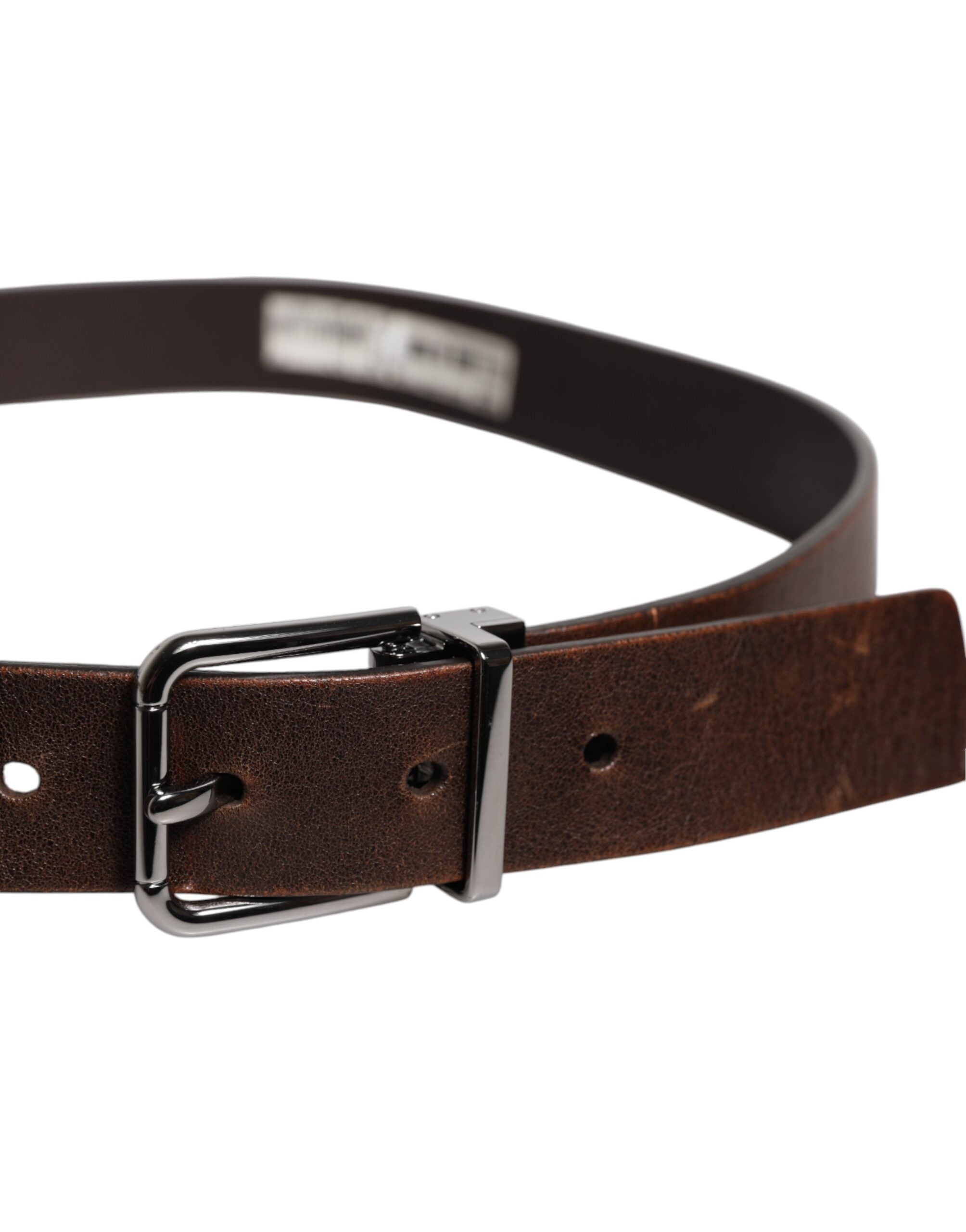 Discover the Dolce & Gabbana Brown Leather Classic Metal Logo Buckle Belt, a timeless piece of exquisite craftsmanship that elevates your style with luxurious elegance.