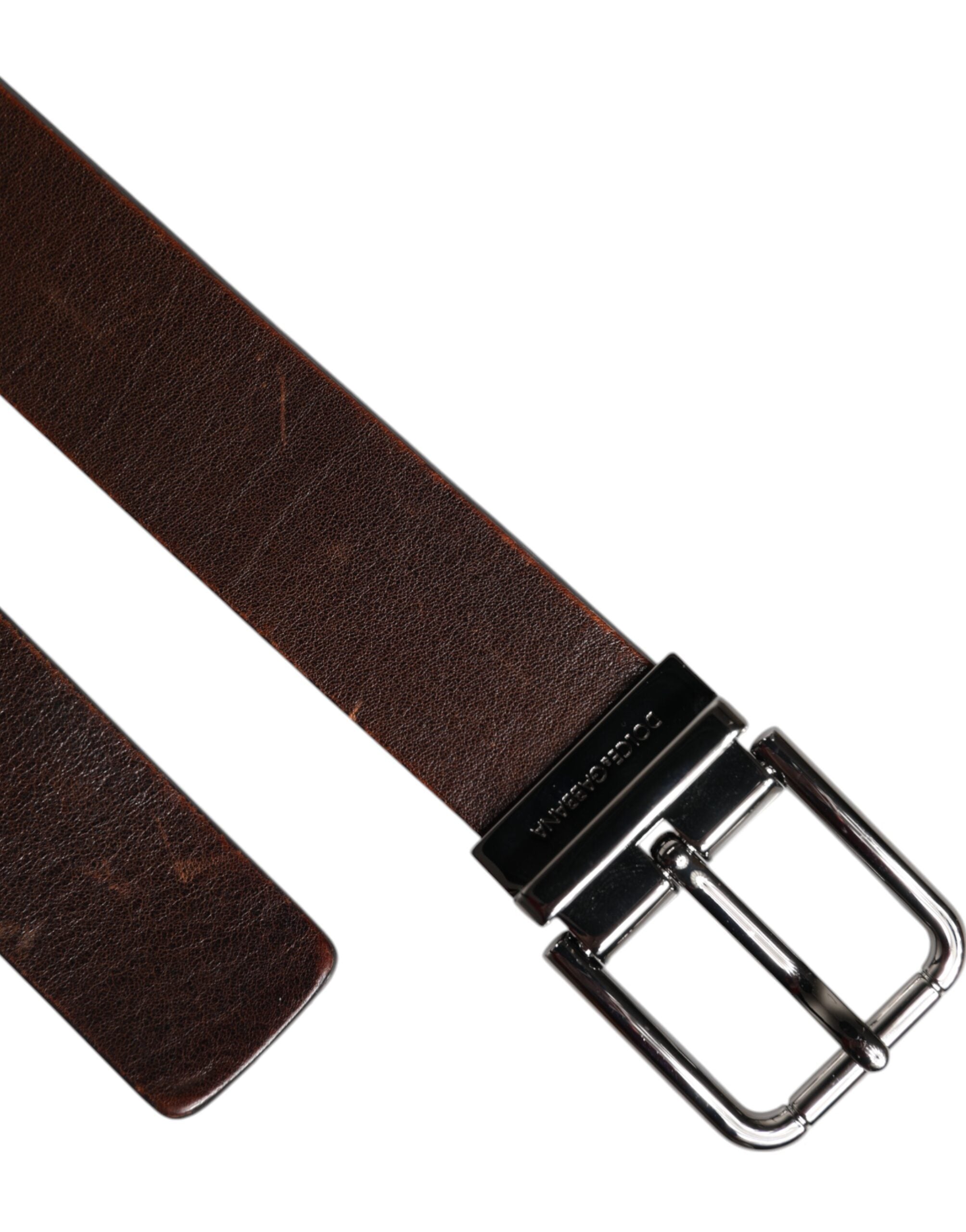 Experience the exquisite elegance of the Dolce & Gabbana Brown Leather Classic Metal Logo Buckle Belt, a timeless accessory that embodies luxurious craftsmanship and sophistication.