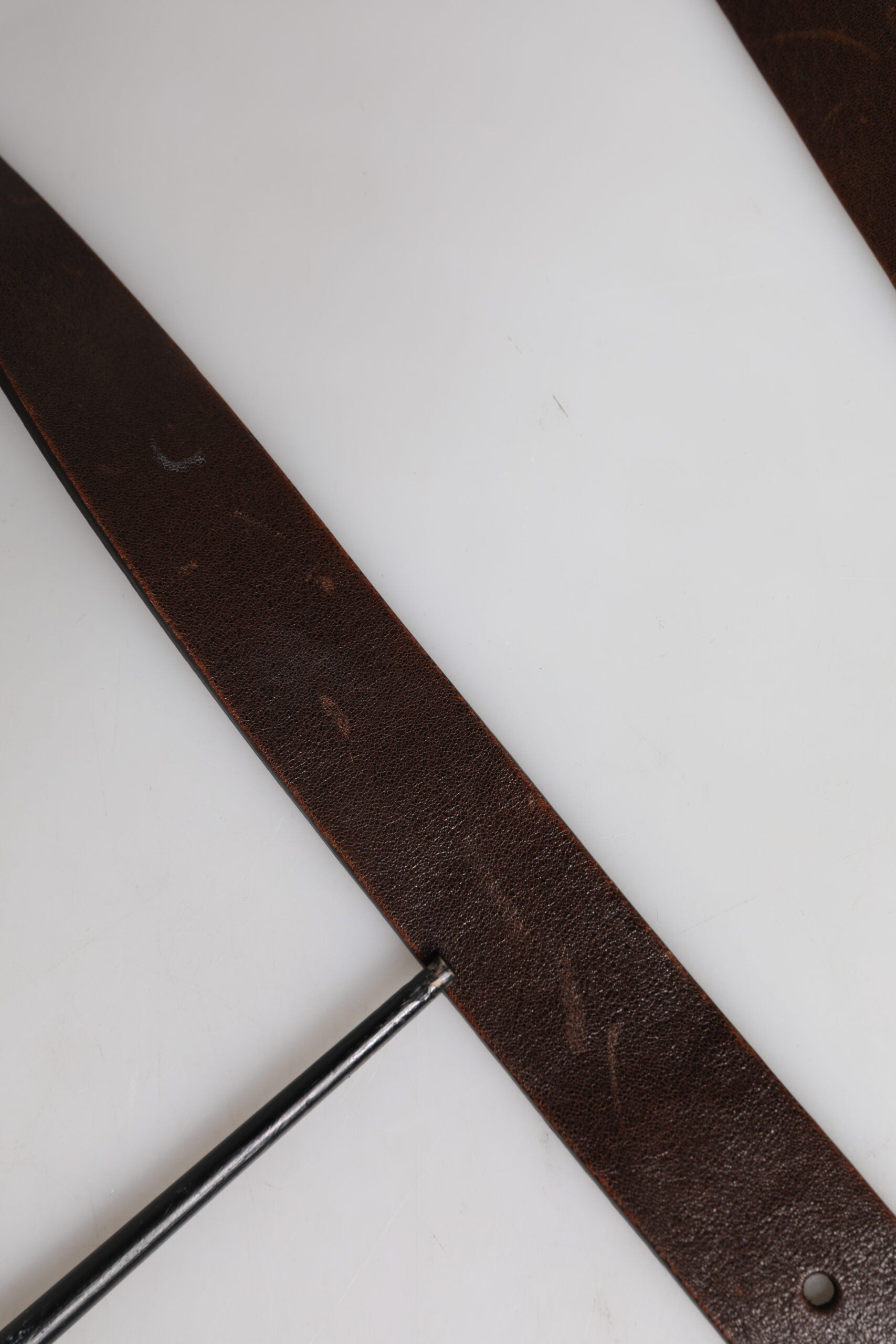 Indulge in the exquisite allure of the Dolce & Gabbana Brown Leather Classic Metal Logo Buckle Belt, a timeless statement of luxury and sophistication, crafted in Italy.