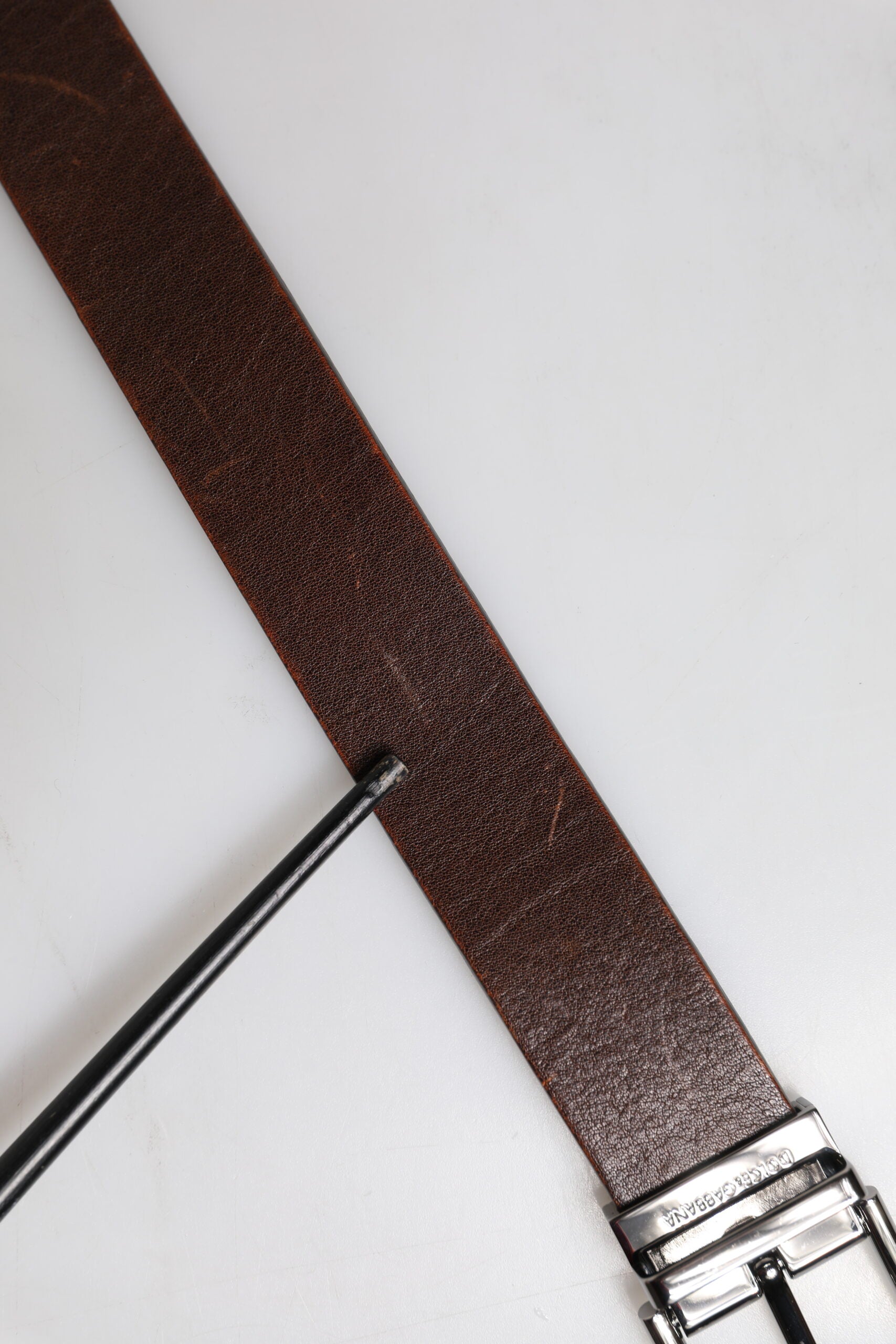 Discover the Dolce & Gabbana Brown Leather Classic Metal Logo Buckle Belt, a masterpiece of Italian craftsmanship that elevates your style with timeless elegance and sophistication.