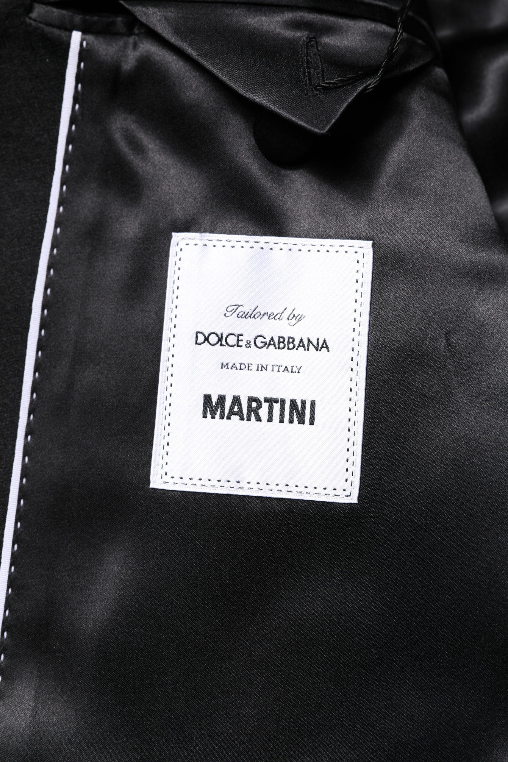 Discover the Dolce & Gabbana Black MARTINI Blazer, a masterpiece of 94% virgin wool and silk, embodying timeless elegance and exquisite Italian craftsmanship for the discerning individual.