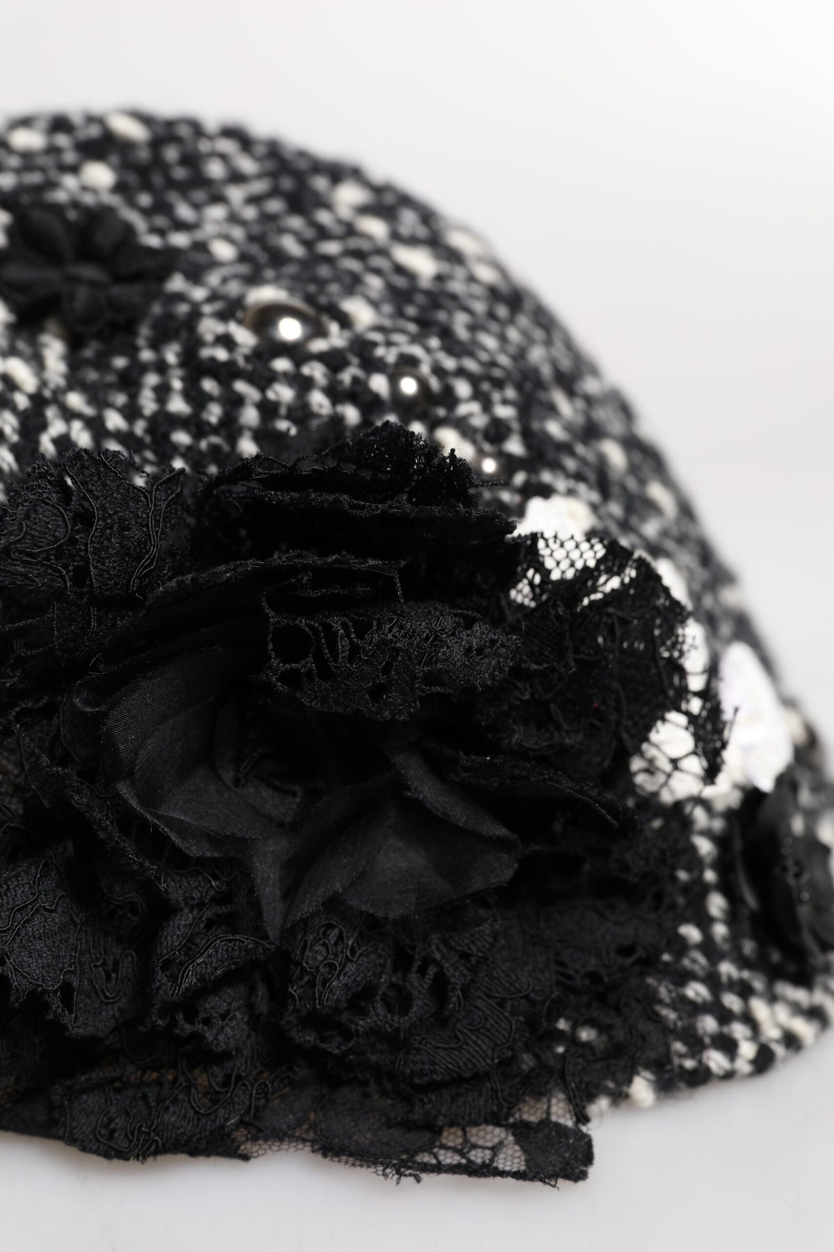 Indulge in the Dolce & Gabbana Black Wool White Floral Embellished Cloche Hat, a masterpiece of Italian craftsmanship that elevates your style with timeless elegance.