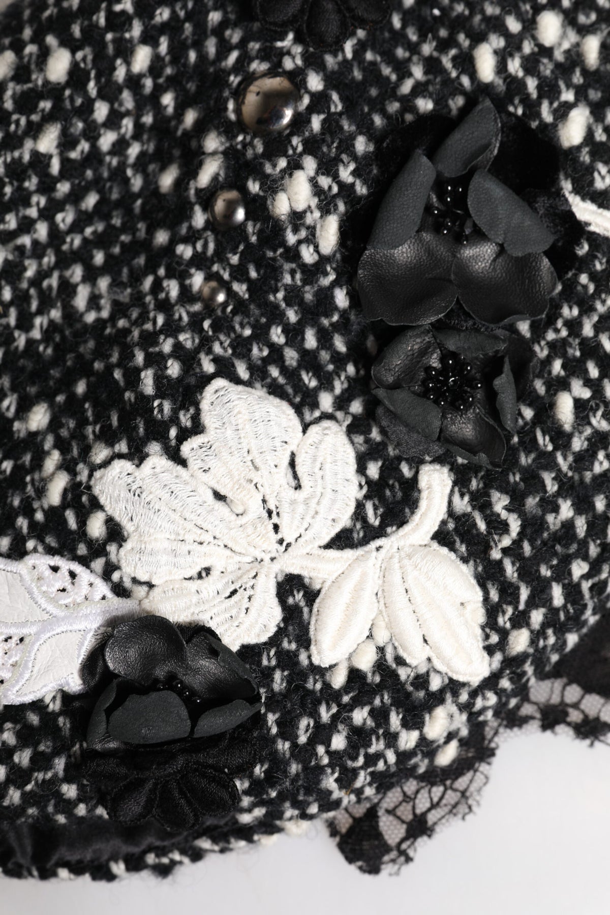 Indulge in the Dolce & Gabbana Black Wool White Floral Embellished Cloche Hat, a masterpiece of Italian craftsmanship that elevates your style with timeless elegance and sophistication.