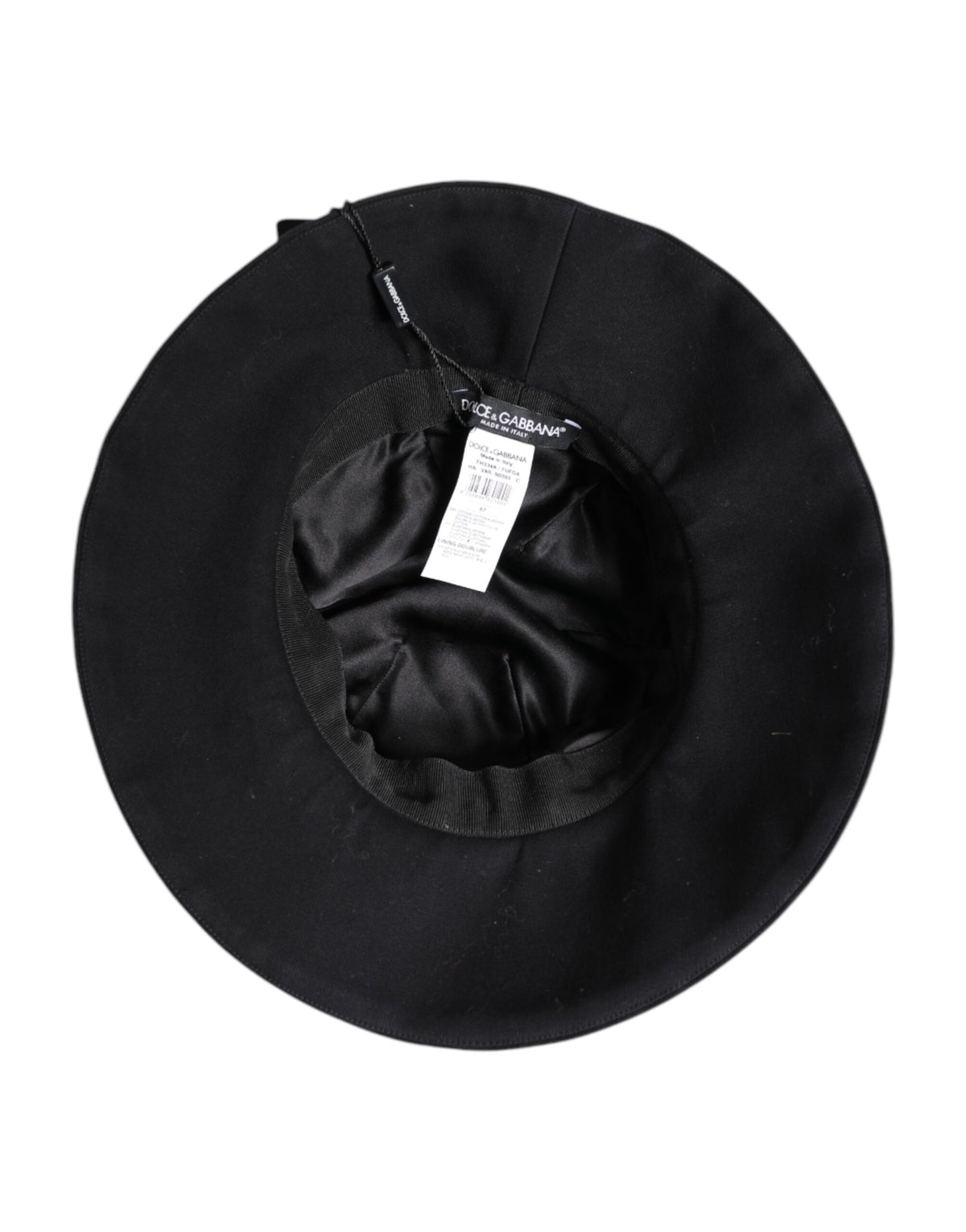 Indulge in the Dolce & Gabbana Black Cotton Wide Brim Bucket Hat, a masterpiece of Italian craftsmanship that elevates your style with timeless elegance and luxurious comfort.