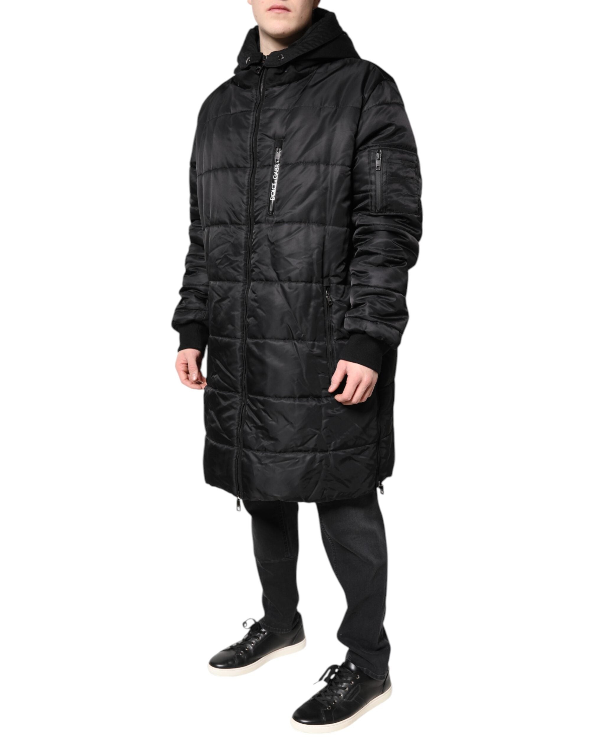 Elevate your winter wardrobe with the Dolce & Gabbana Black Hooded Parka, a luxurious blend of nylon and cotton, embodying sophistication and timeless elegance.