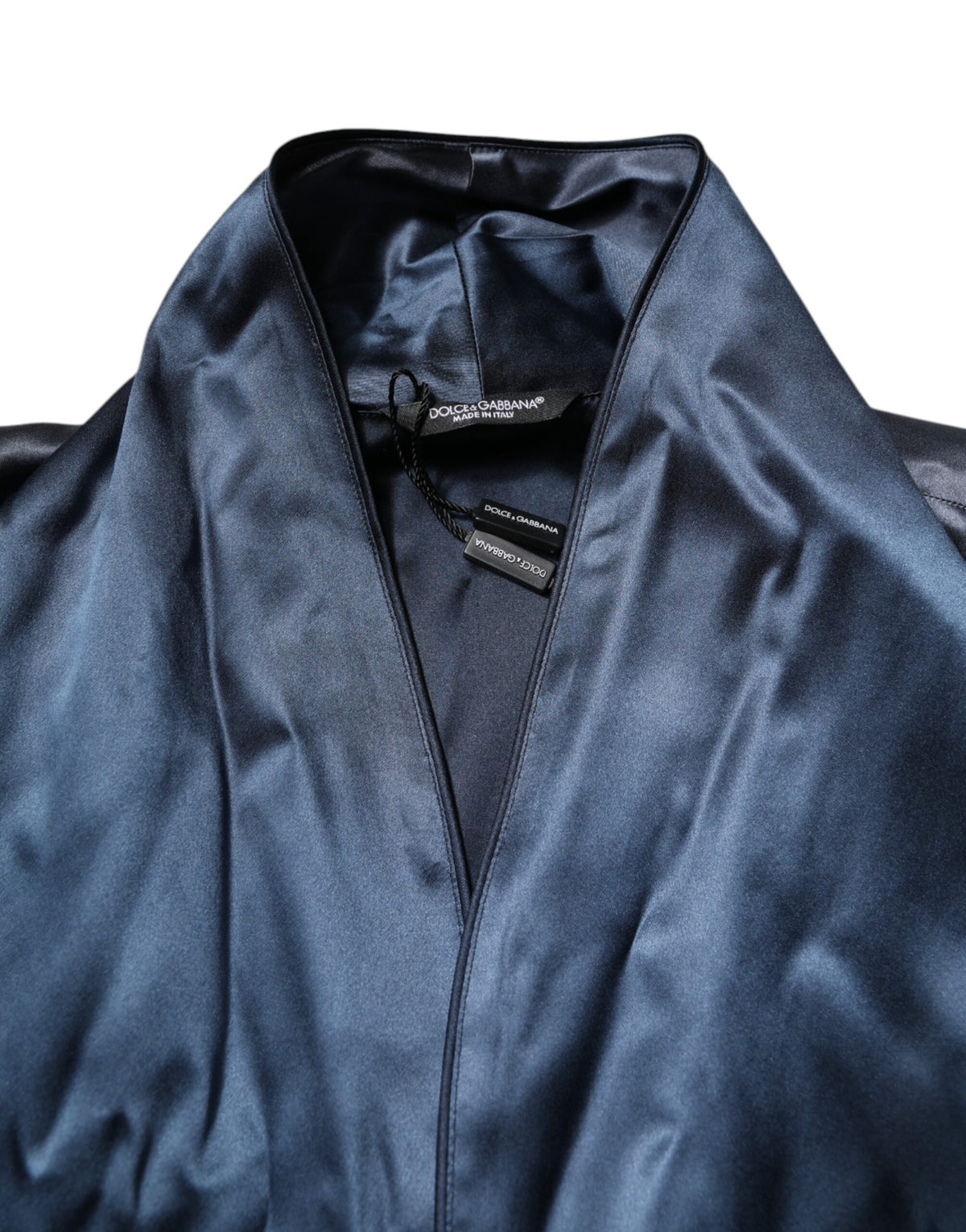 Indulge in the exquisite Dolce & Gabbana Blue Solid Silk Men Wrap Robe Coat Jacket, a symbol of Italian craftsmanship that elevates your style and embodies luxury.