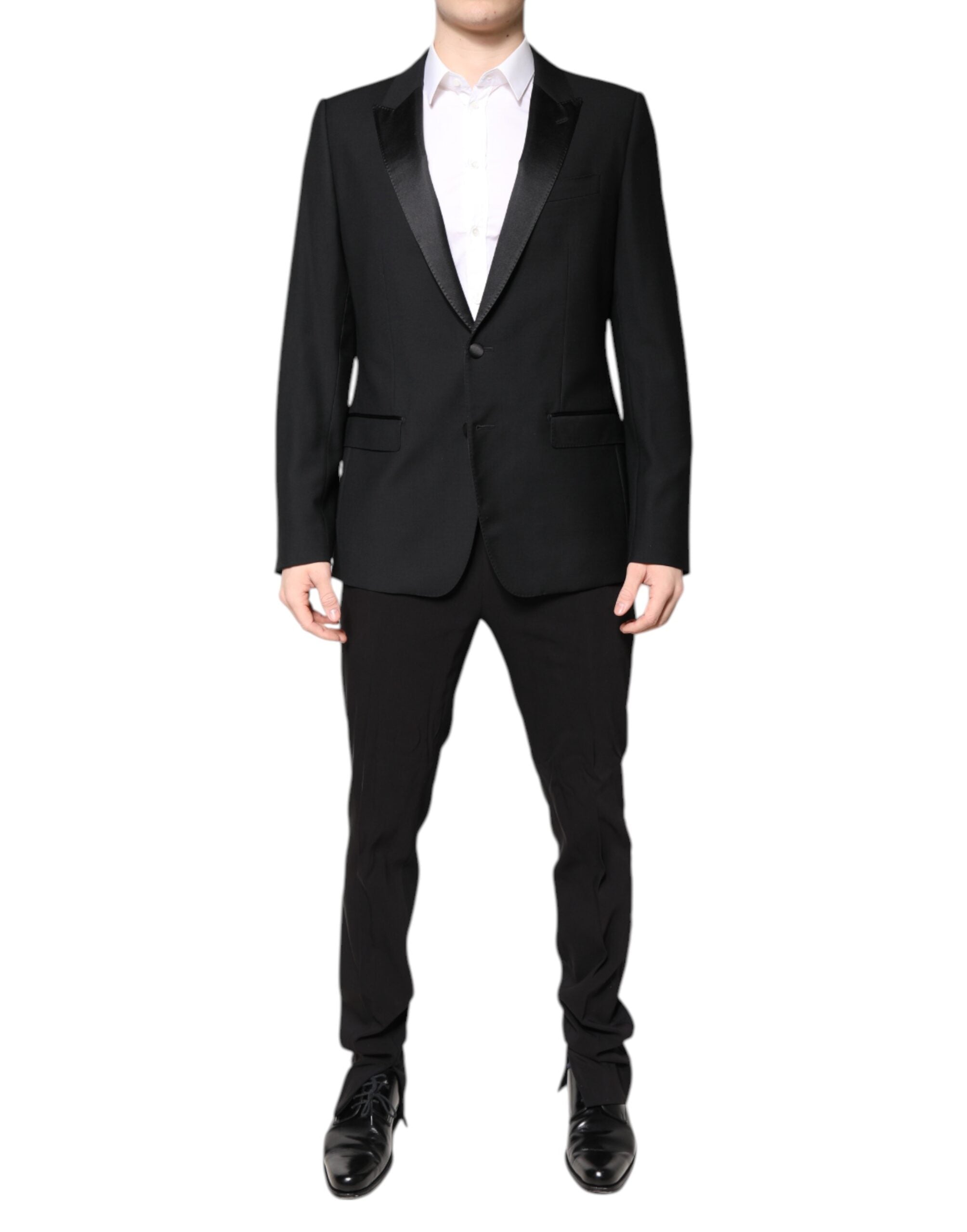 Indulge in the exquisite Dolce & Gabbana Black Wool Single Breasted Suit, a masterpiece of luxurious craftsmanship, perfect for those who embody elegance and sophistication.