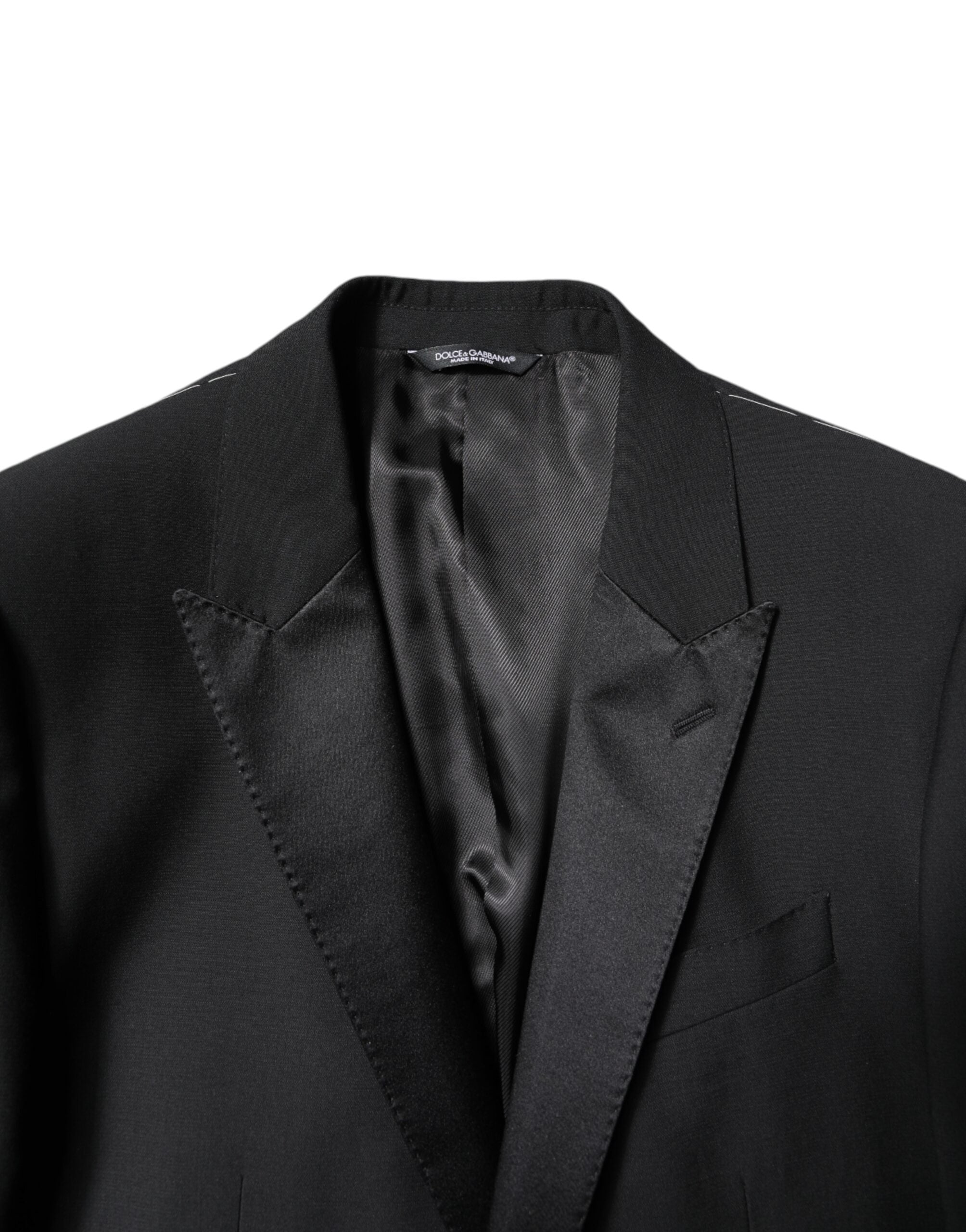 Experience the opulent elegance of the Dolce & Gabbana Black Wool Single Breasted Suit, crafted from a luxurious blend of virgin wool and silk for timeless sophistication.