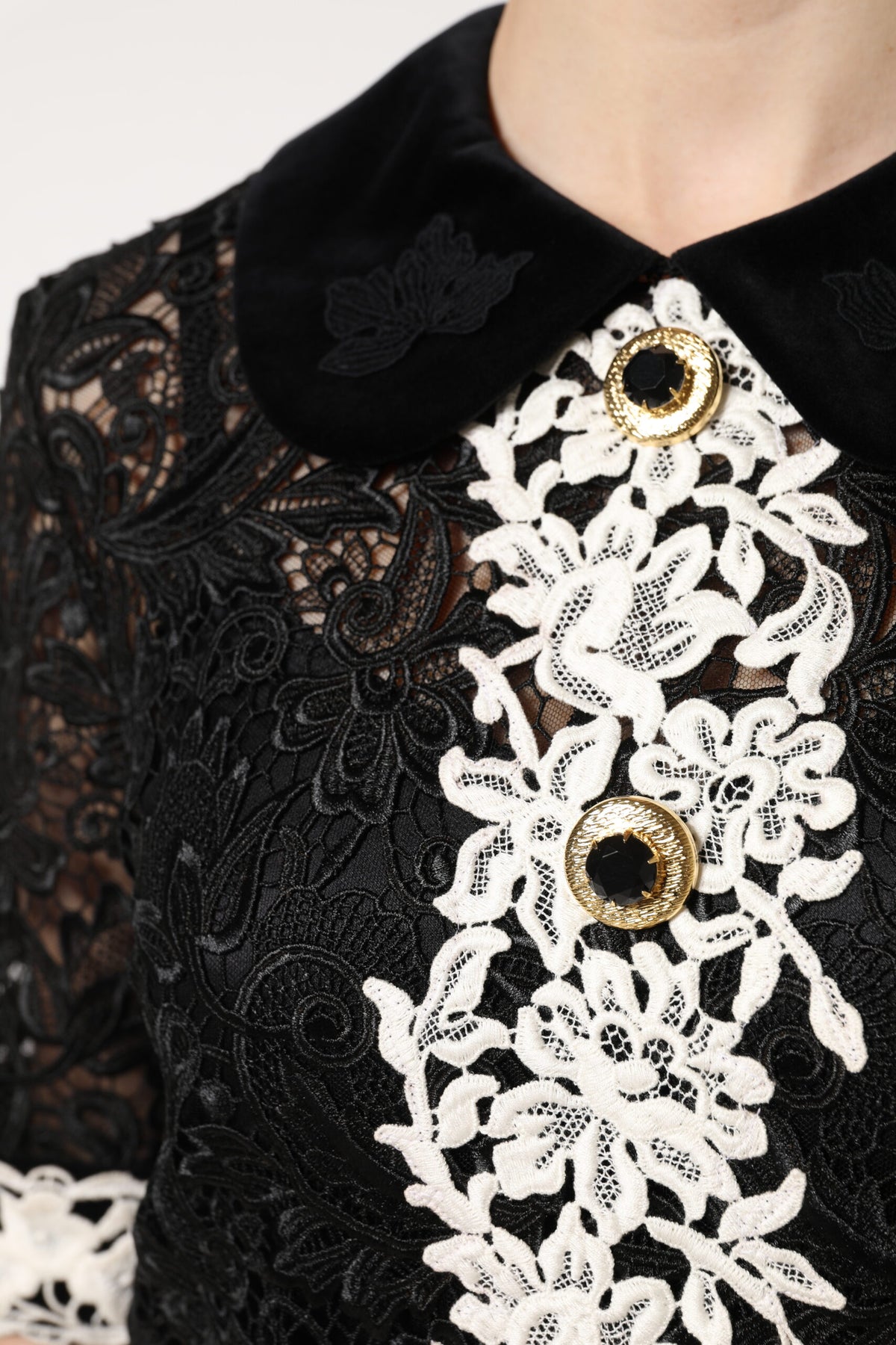 Indulge in the exquisite allure of the Dolce & Gabbana Black Floral Lace Embellished Mini Dress, a masterpiece of Italian craftsmanship that embodies timeless elegance and sophistication.