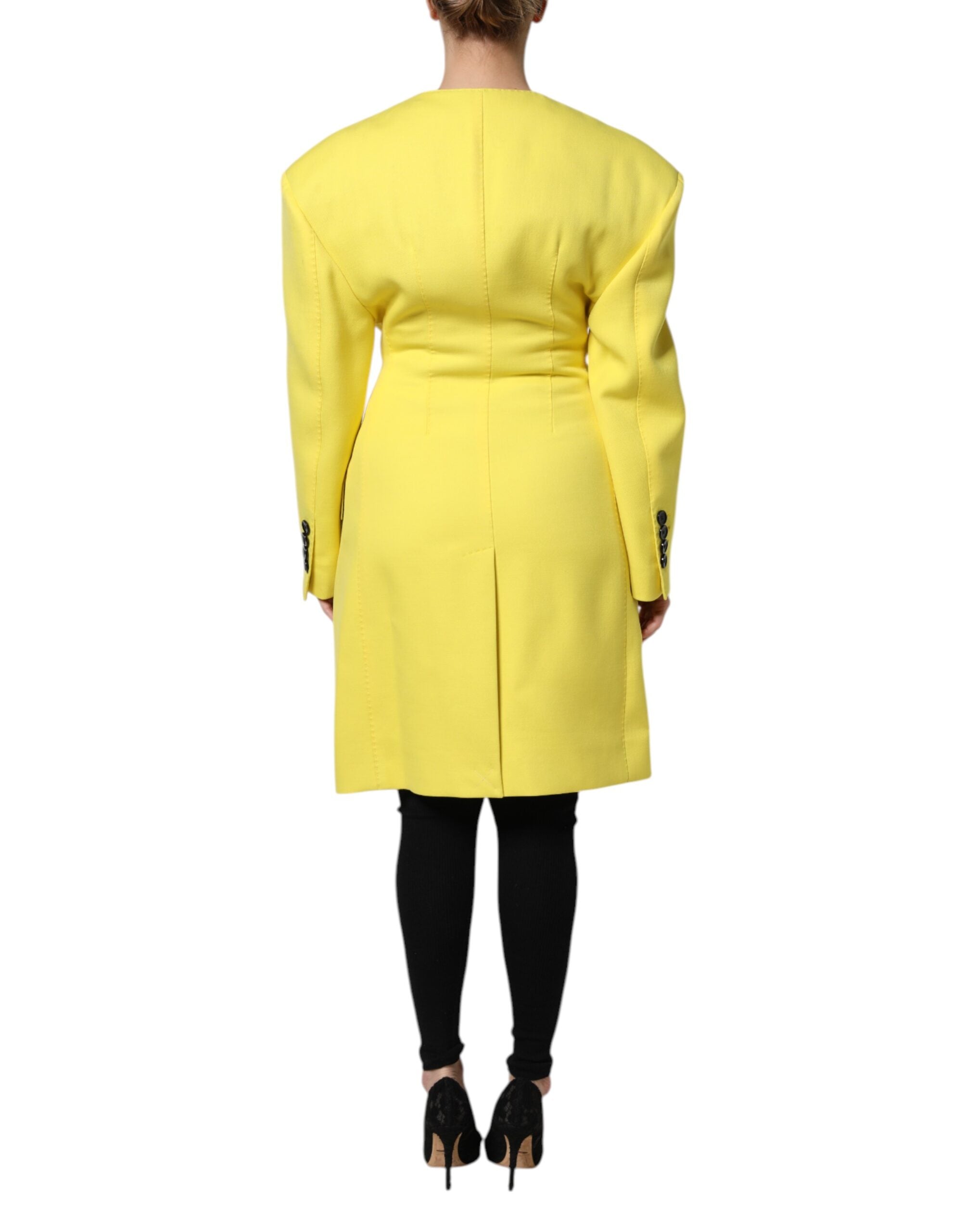 Indulge in the exquisite Dolce & Gabbana Yellow Double Breasted Trench Coat, a masterpiece of 100% virgin wool that embodies timeless elegance and luxurious craftsmanship.