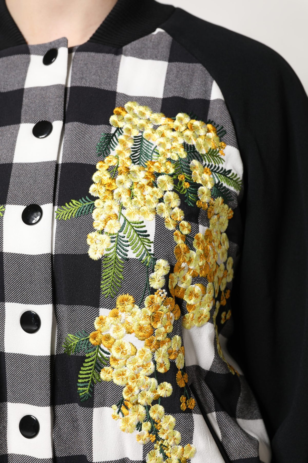 Elevate your wardrobe with the Dolce & Gabbana Black White Check Floral Button Down Jacket, a masterpiece of Italian craftsmanship, blending luxurious fabrics for timeless elegance.