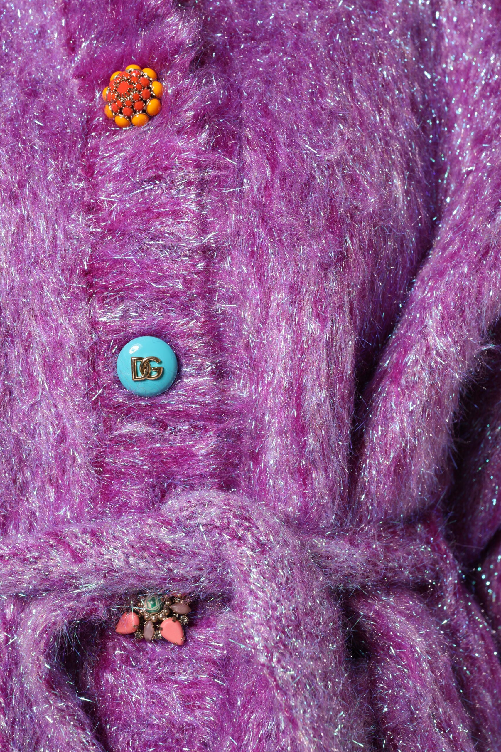 Discover the Dolce & Gabbana Purple Button Embellished Trench Coat, a luxurious blend of wool and mohair, epitomizing exquisite craftsmanship and timeless elegance.