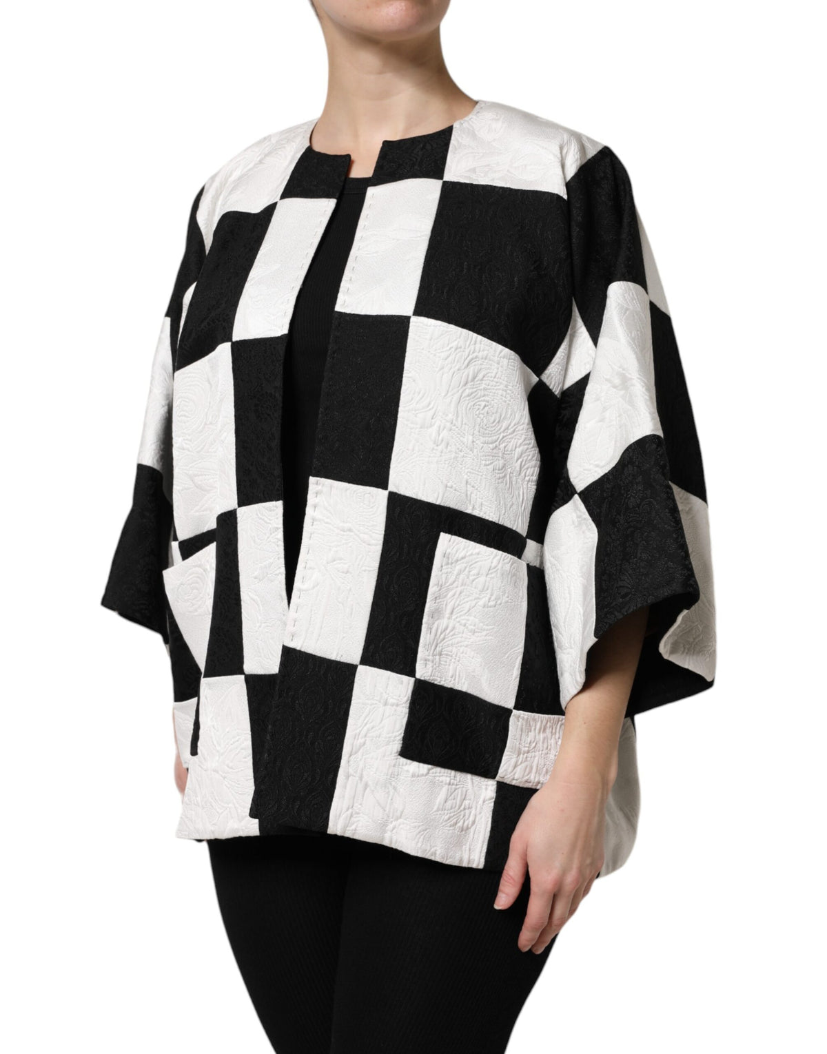 Elevate your wardrobe with the Dolce & Gabbana White Black Patchwork Jacquard Blazer, a luxurious masterpiece of Italian craftsmanship that embodies timeless elegance and sophistication.