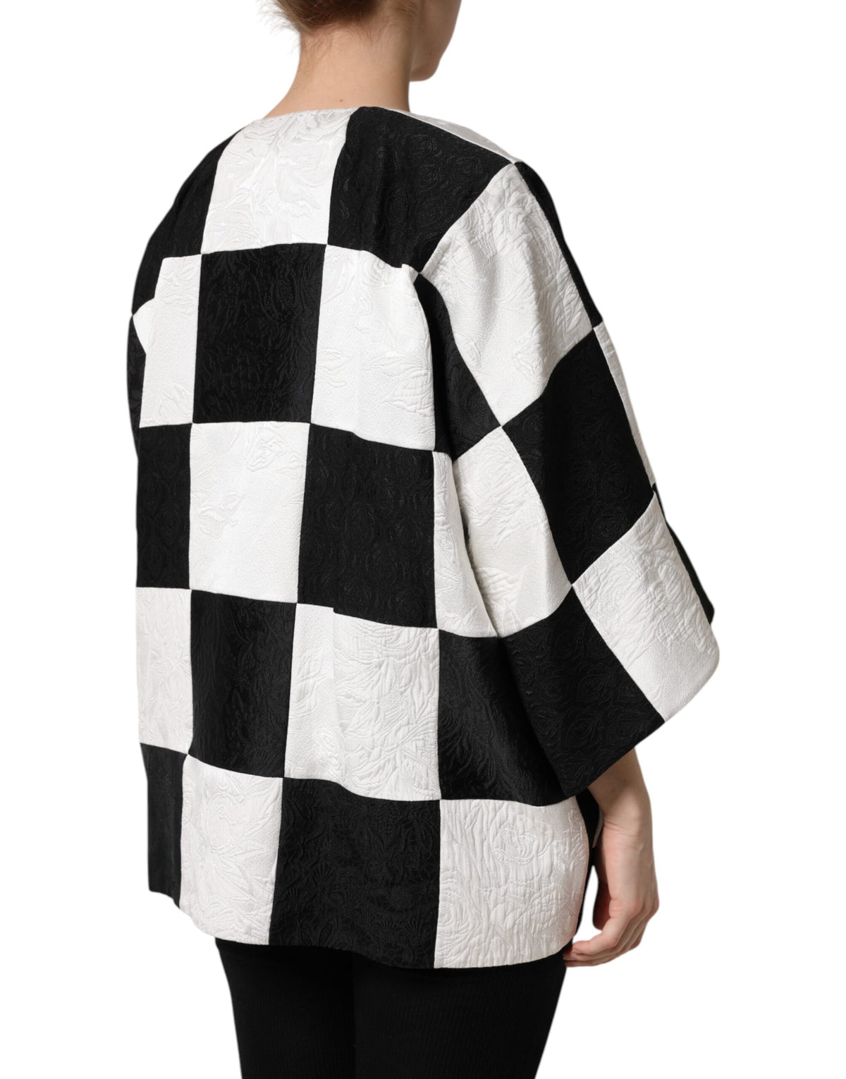 Experience the exquisite Dolce & Gabbana White Black Patchwork Jacquard Blazer, a luxurious statement piece crafted from premium materials, embodying timeless elegance and Italian artistry.