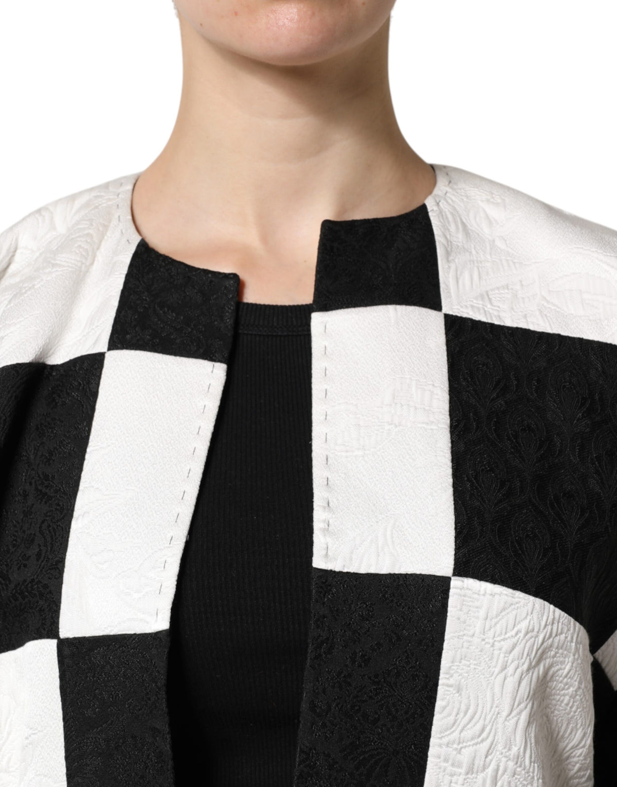 Elevate your wardrobe with the Dolce & Gabbana White Black Patchwork Jacquard Blazer, a masterpiece of Italian craftsmanship that embodies timeless elegance and sophisticated allure.