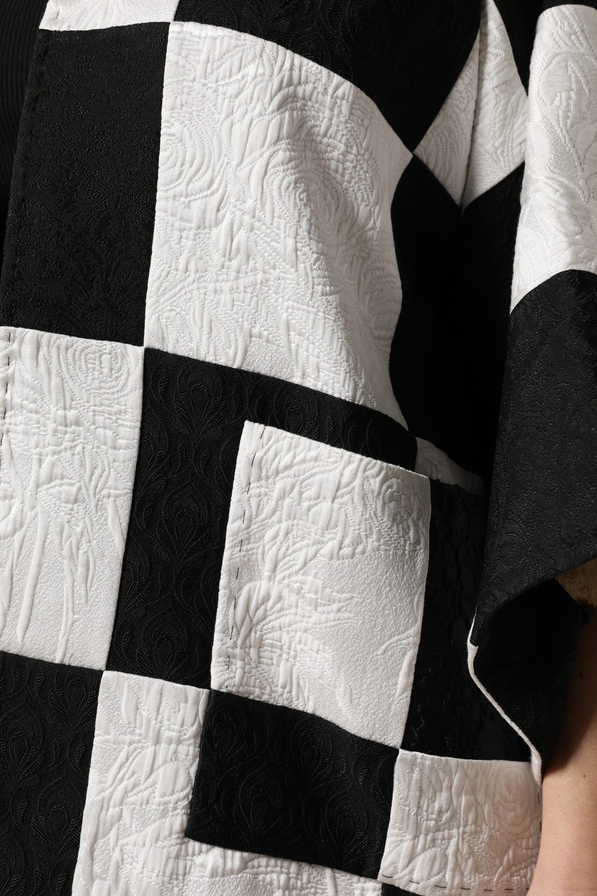 Elevate your wardrobe with the Dolce & Gabbana White Black Patchwork Jacquard Blazer, a masterpiece of Italian craftsmanship that embodies timeless elegance and sophisticated allure.