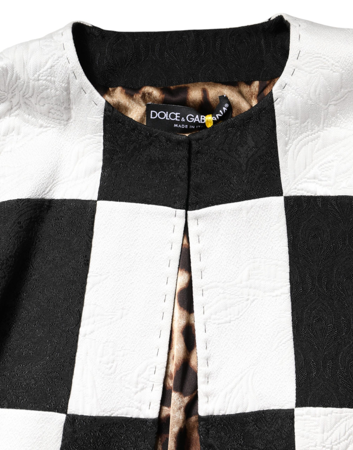Elevate your wardrobe with the Dolce & Gabbana White Black Patchwork Jacquard Blazer, a masterpiece of Italian craftsmanship that embodies timeless luxury and sophistication.