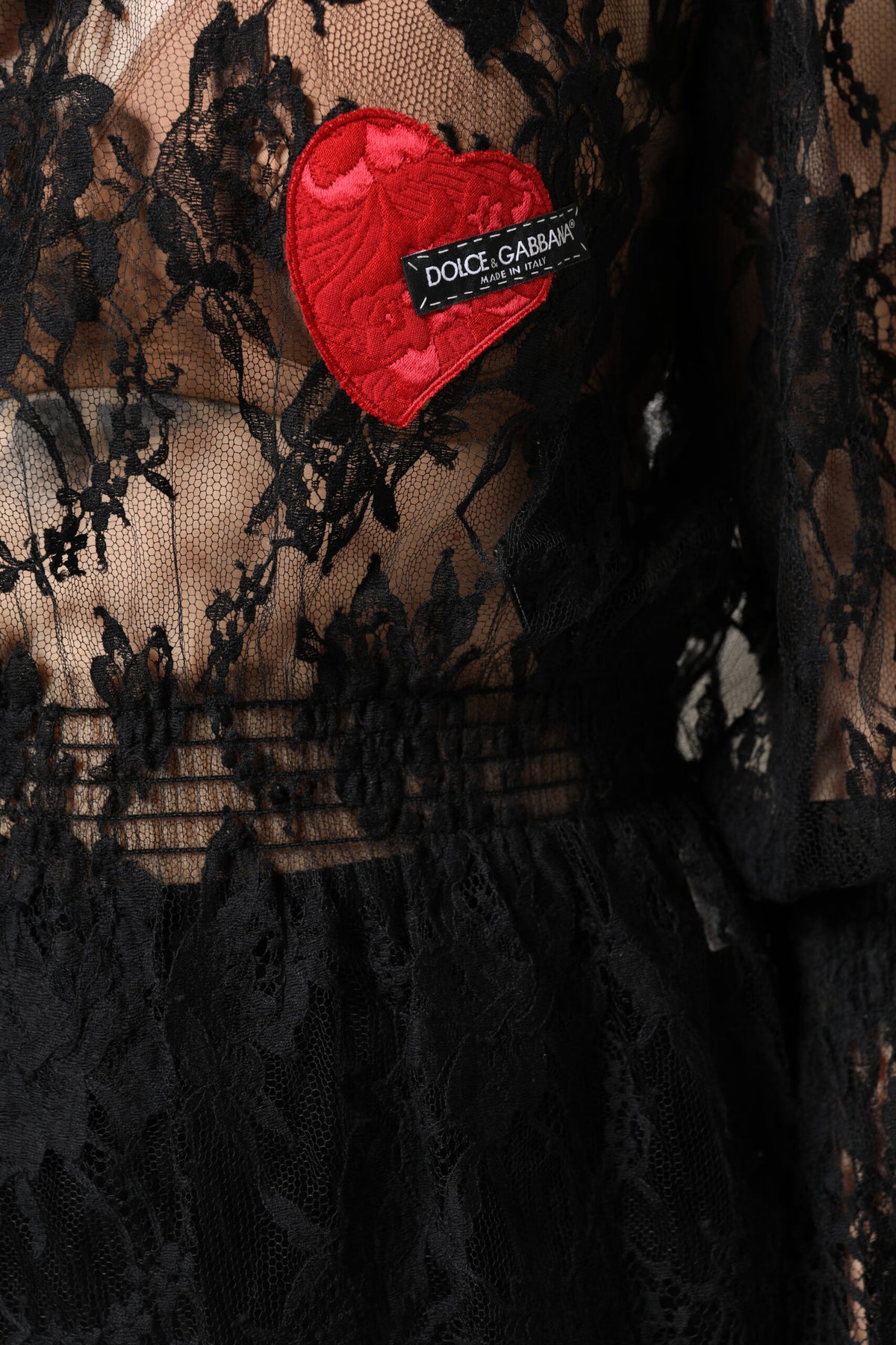 Indulge in the exquisite Dolce & Gabbana Black Cotton Floral Lace Blouse, a masterpiece of Italian craftsmanship that embodies timeless elegance and modern allure.