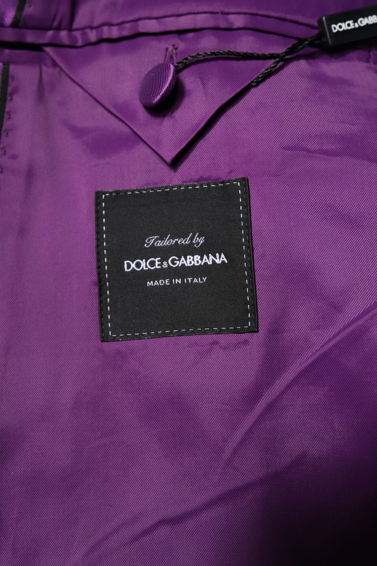 Elevate your wardrobe with the Dolce & Gabbana Purple Double Breasted Blazer, a masterpiece of Italian craftsmanship, blending luxurious materials with timeless elegance for the discerning individual.