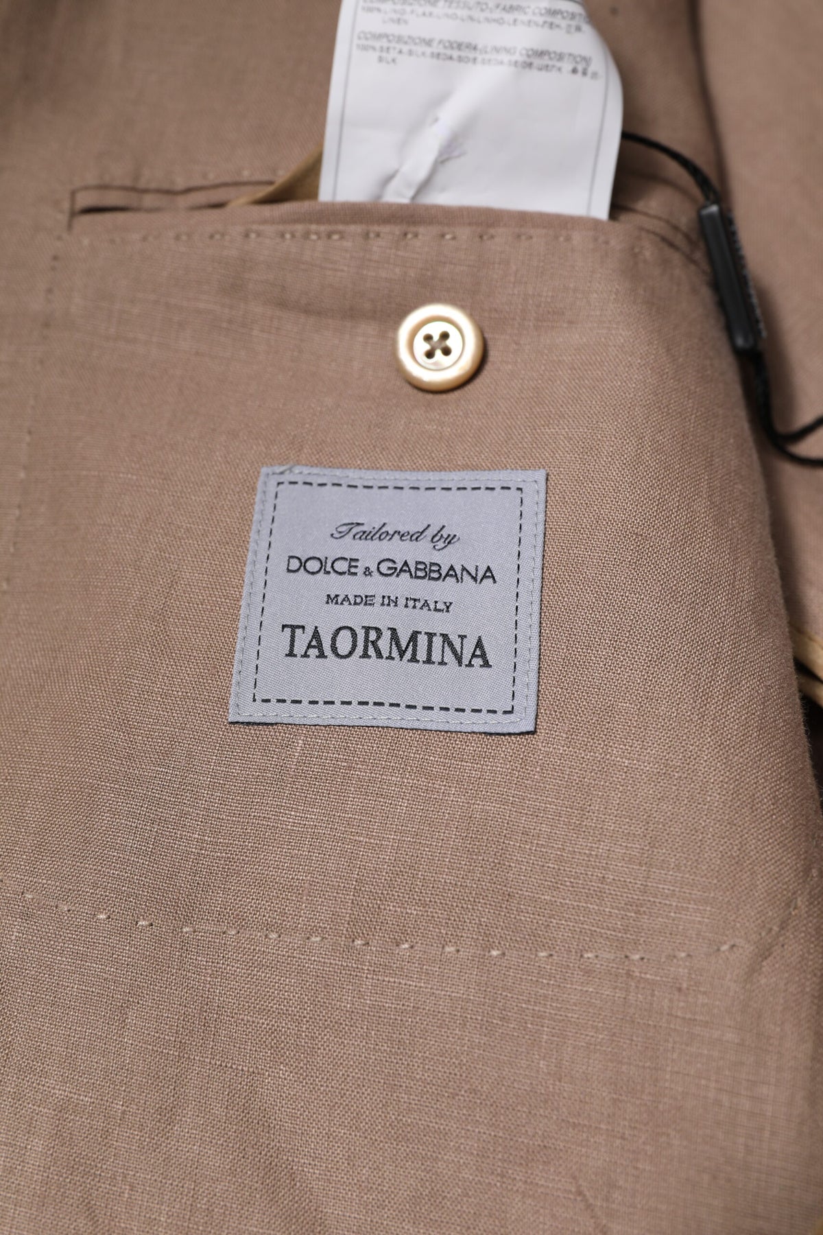 Discover the Dolce & Gabbana Beige TAORMINA Single Breasted Coat Blazer, a masterpiece of 100% flax and silk, embodying timeless elegance and exquisite Italian craftsmanship.
