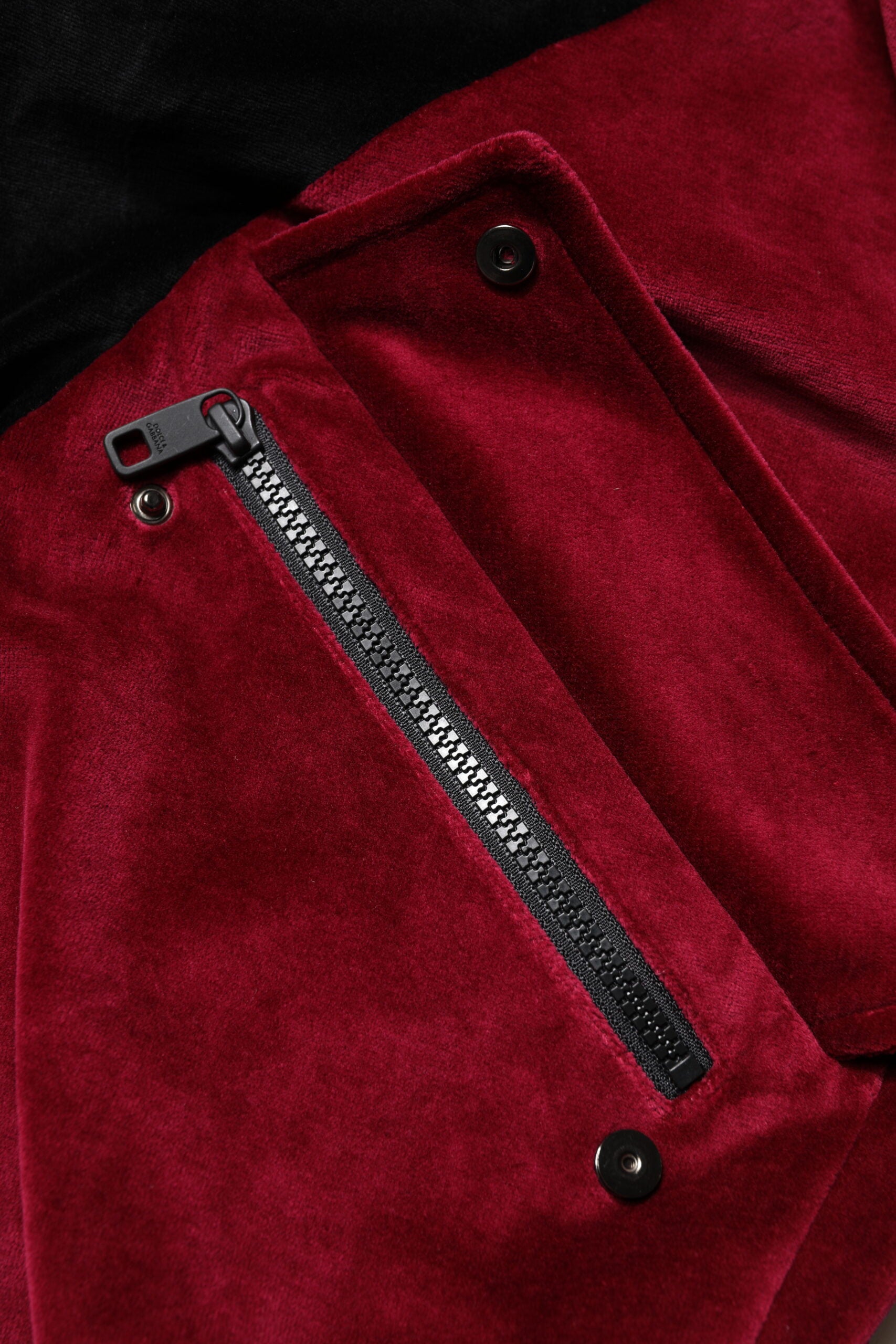 Elevate your wardrobe with the Dolce & Gabbana Red Black Cotton Logo FullZip Bomber Jacket, a masterpiece of Italian craftsmanship that embodies luxury and sophistication.