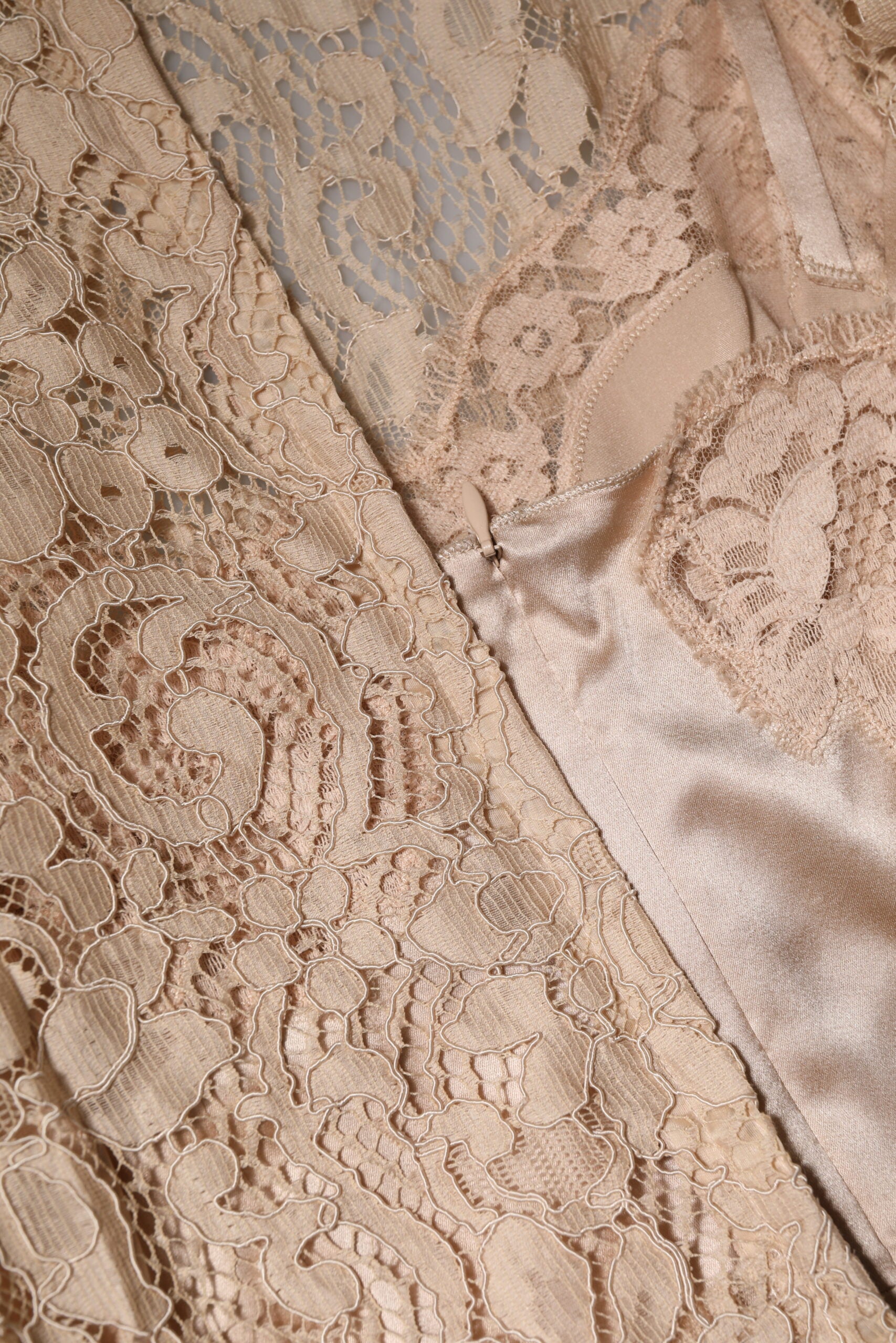 Experience the exquisite elegance of the Dolce & Gabbana Beige Floral Lace Sleeveless Sheath Dress, a timeless masterpiece crafted in Italy for the discerning muse.