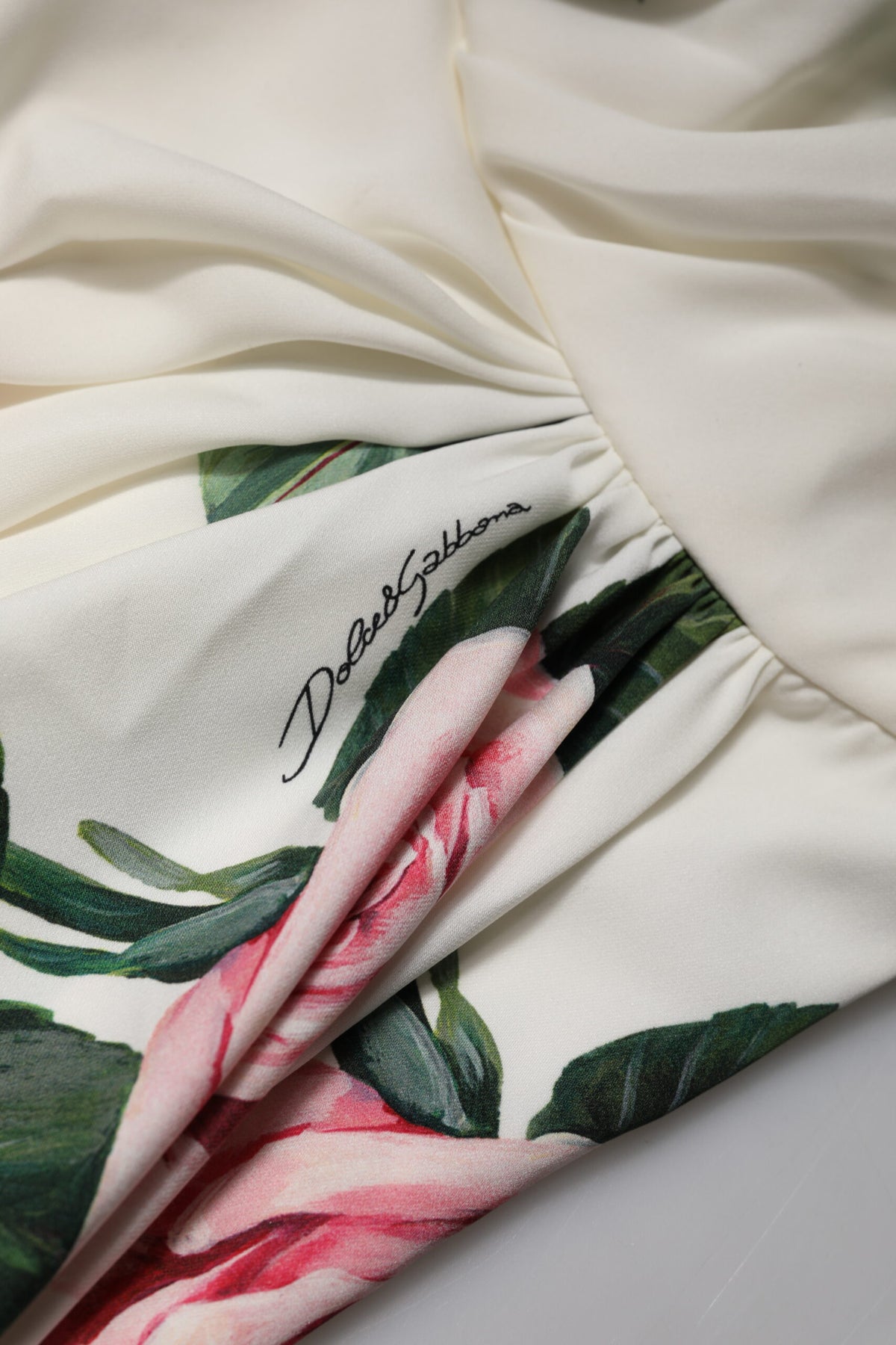 Indulge in the exquisite allure of the Dolce & Gabbana White Floral One Shoulder Sheath Midi Dress, crafted from luxurious silk for a timeless elegance that captivates.