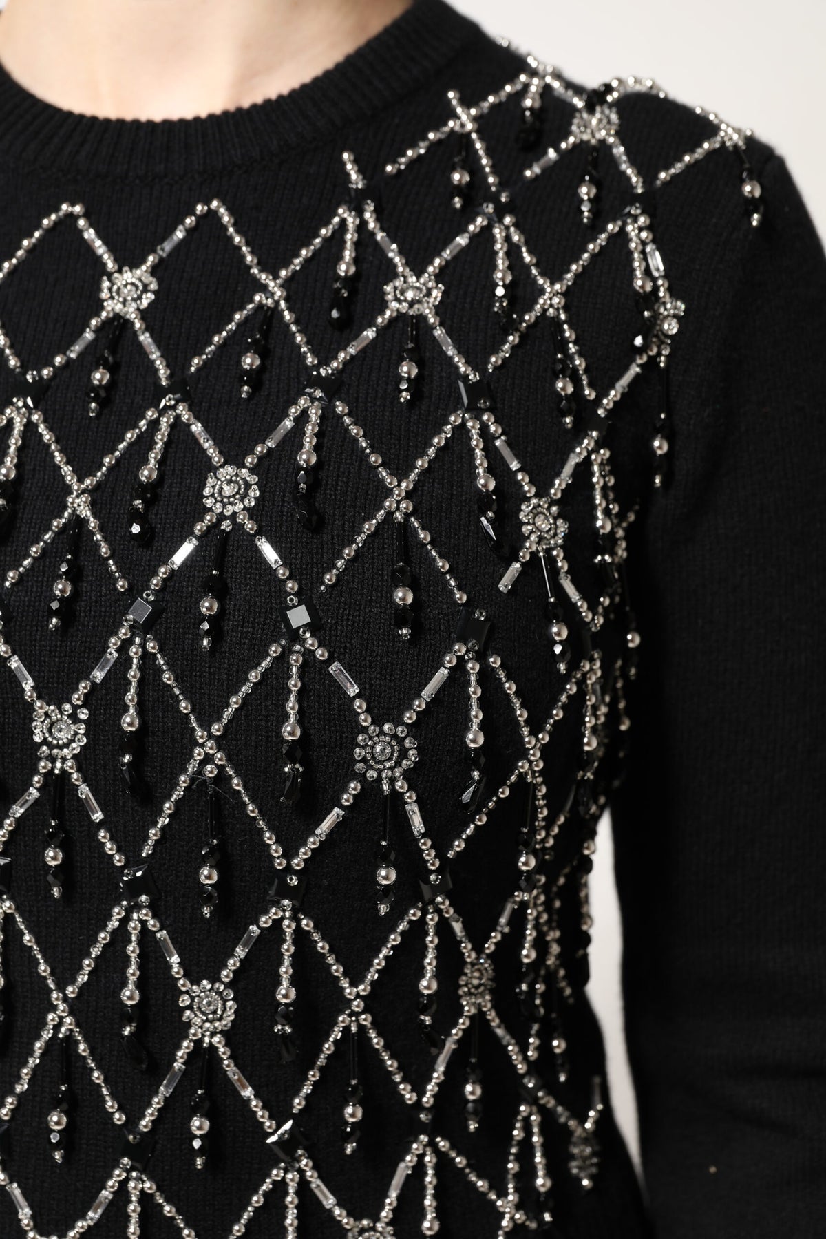 Experience the exquisite allure of the Dolce & Gabbana Black Cashmere Embellished Long Sleeves Top, a testament to Italian craftsmanship and timeless elegance.