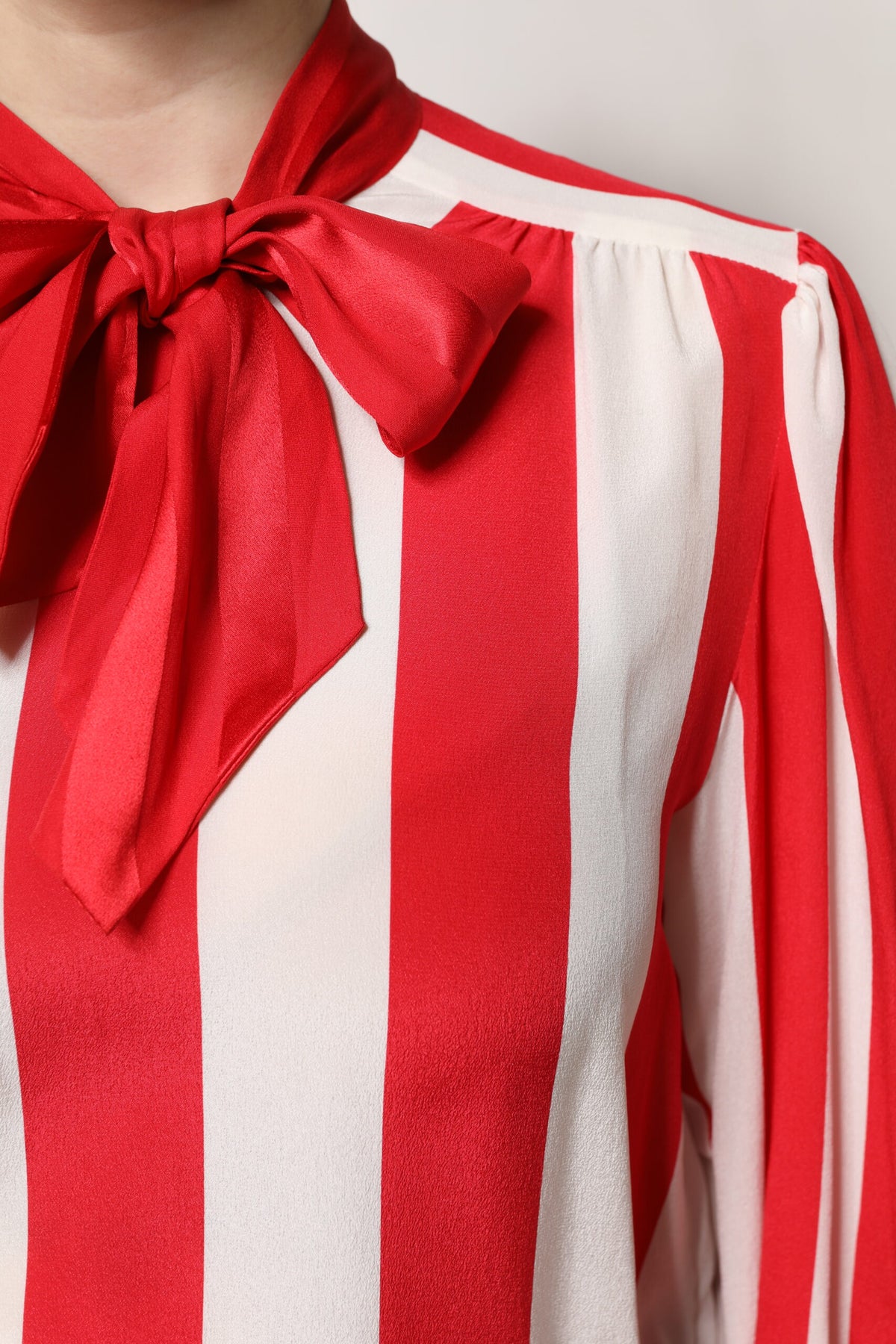 Indulge in the allure of the Dolce & Gabbana Red White Stripes Ascot Collar Blouse, a silk masterpiece that embodies timeless elegance and Italian craftsmanship for the discerning individual.