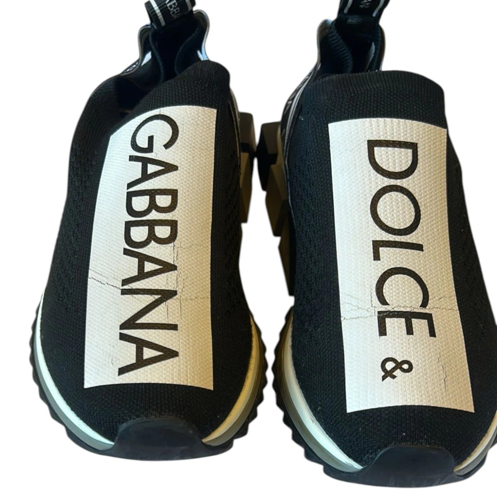 Experience the allure of Dolce & Gabbana's Black White Slip On Sorrento Sneakers, crafted from luxurious stretch mesh, embodying timeless Italian craftsmanship and sophistication.