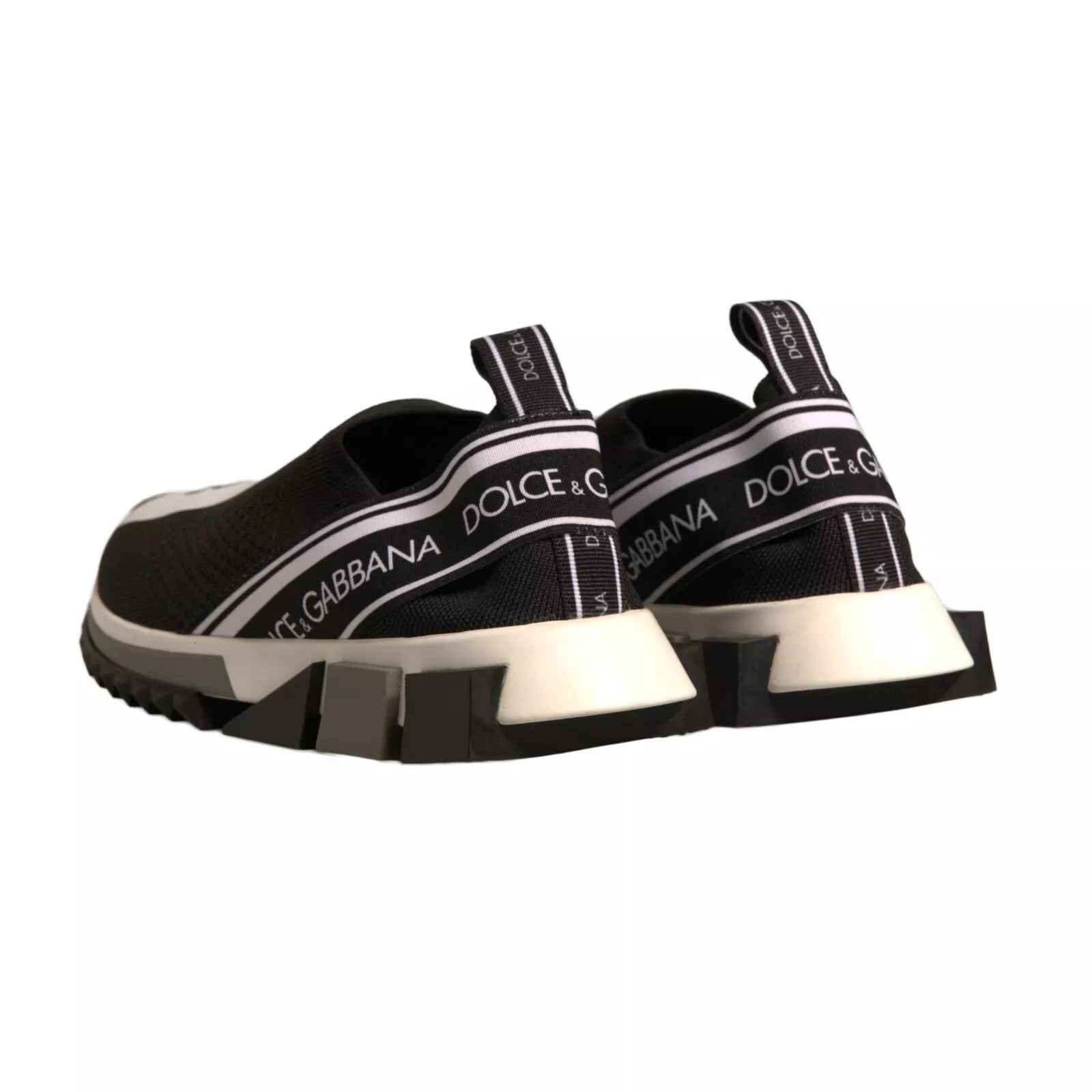 Experience the allure of Dolce & Gabbana's Black White Slip On Sorrento Sneakers, where luxurious stretch mesh meets exquisite Italian craftsmanship for timeless elegance.