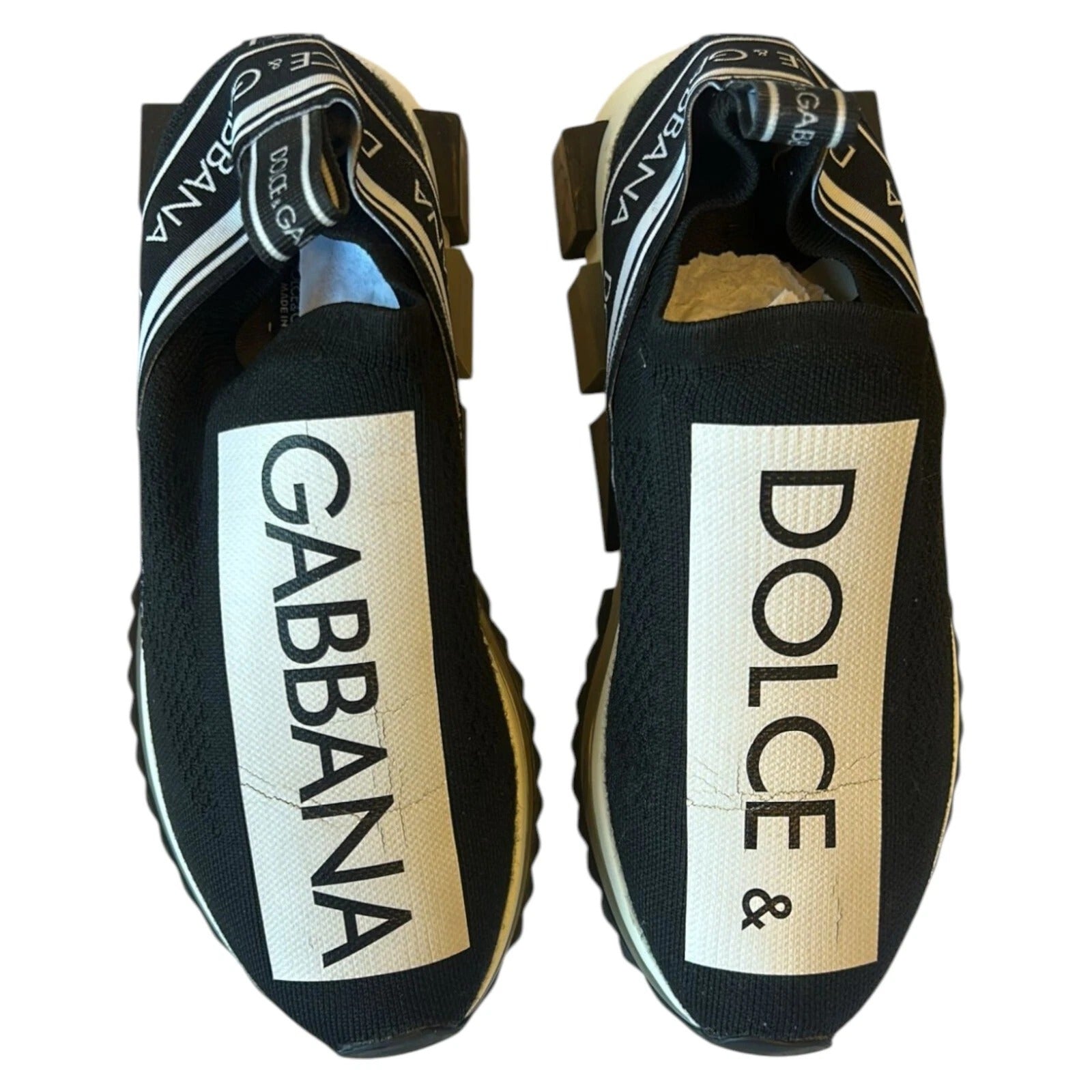 Experience the allure of Dolce & Gabbana's Black White Slip On Sorrento Sneakers, where luxurious stretch mesh meets exquisite Italian craftsmanship for timeless elegance.