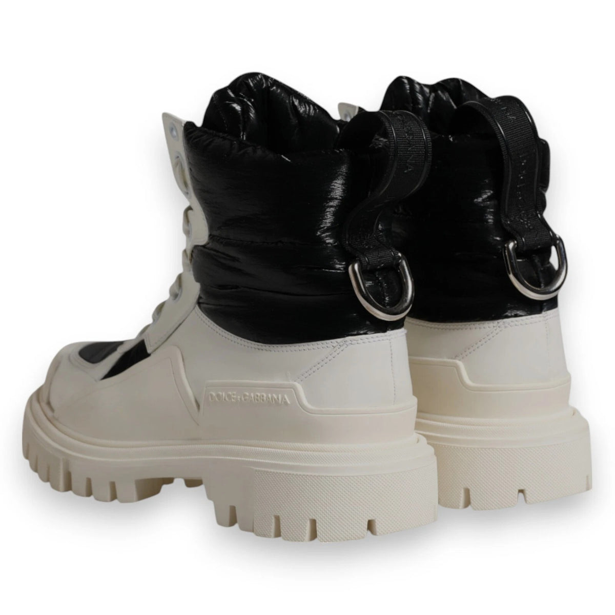Experience the exquisite Dolce & Gabbana White Padded Mid Calf Lace Up Boots, crafted in Italy from premium materials, embodying luxury and sophistication for the discerning individual.
