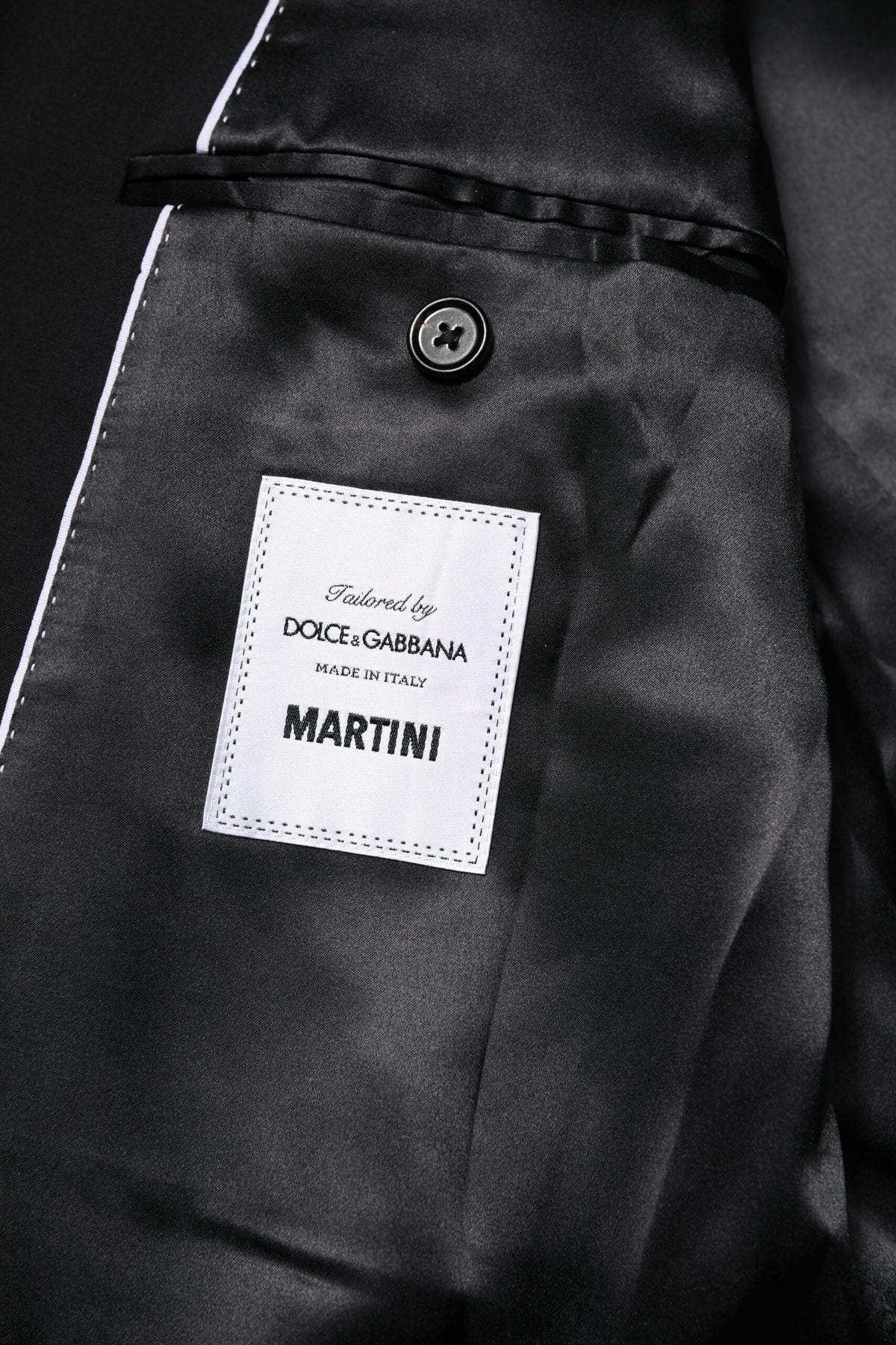 Indulge in the allure of the Dolce & Gabbana Black MARTINI Double Breasted Suit Jacket, where exquisite virgin wool meets silk lining for timeless elegance and sophisticated style.