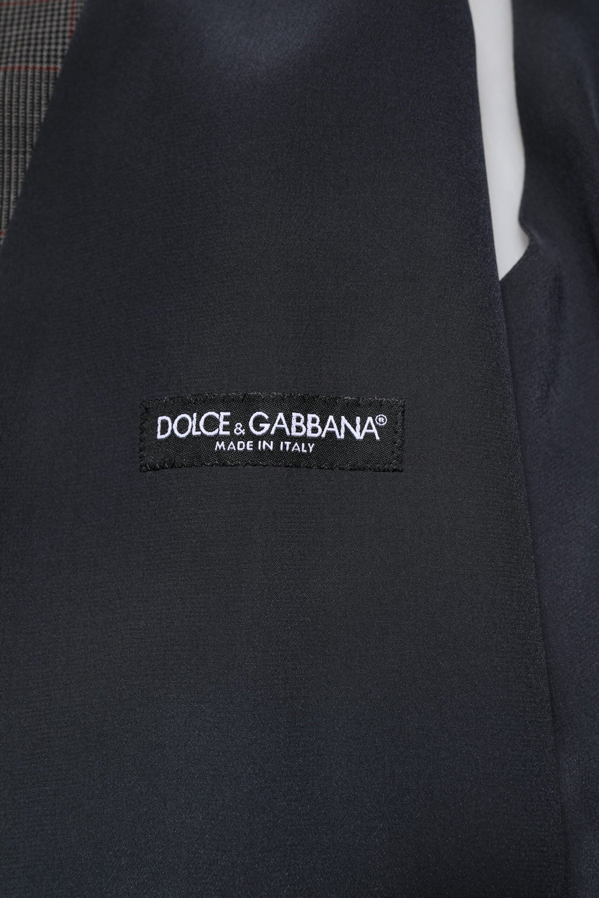 Elevate your wardrobe with the Dolce & Gabbana Gray Plaid Wool Formal Dress Waistcoat Vest, a masterpiece of 100% virgin wool and silk lining, embodying timeless elegance and artisanal excellence.