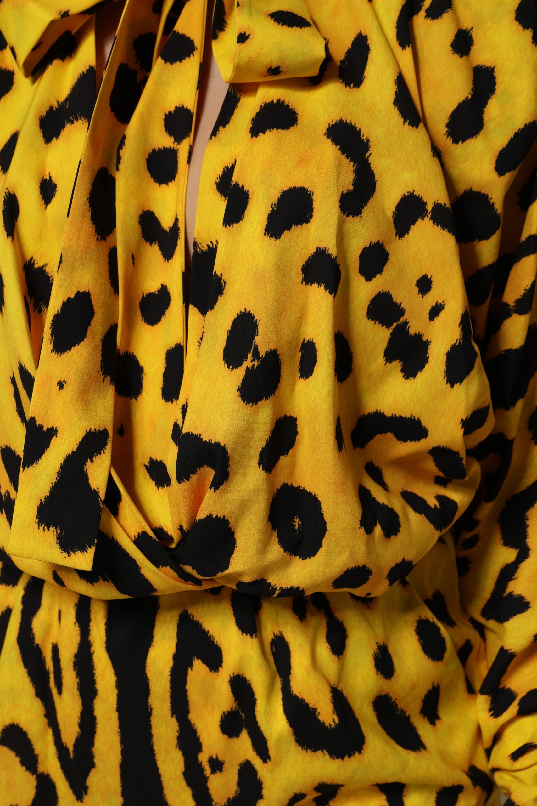 Indulge in the exquisite Dolce & Gabbana Yellow Leopard Long Sleeves Jumpsuit Dress, a luxurious silk masterpiece that embodies elegance and confidence for every occasion.