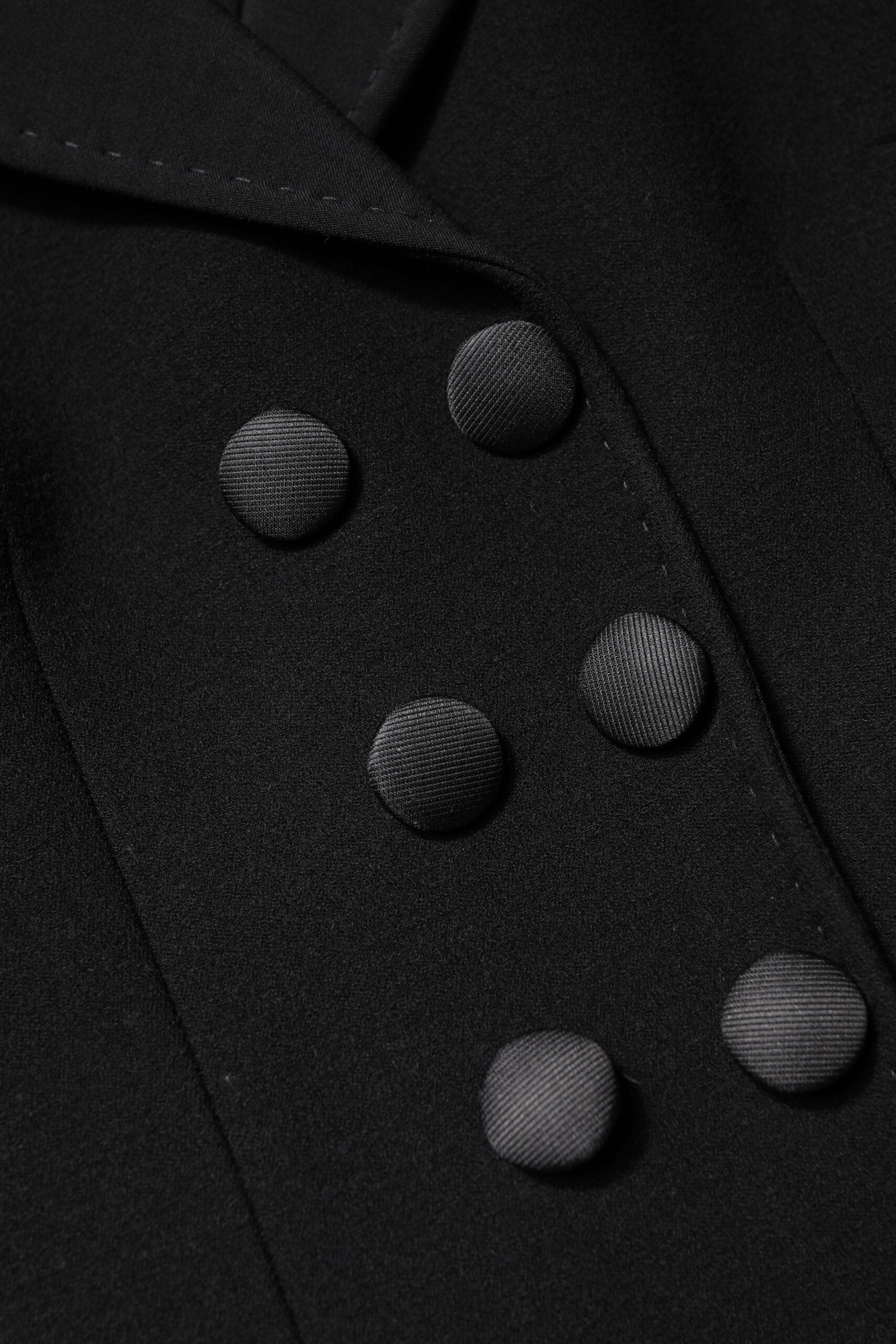 Indulge in the exquisite Dolce & Gabbana Black Wool Double Breasted Coat Jacket, a timeless blend of luxury and sophistication, crafted for the discerning individual.