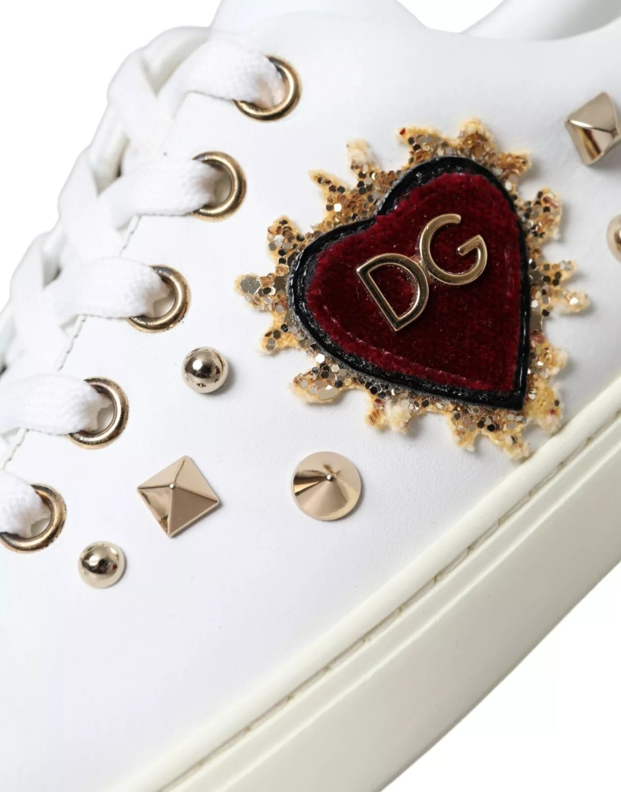 Elevate your style with Dolce & Gabbana's Portofino White Leather Sneakers, crafted from luxurious calf leather, adorned with exquisite heart details for the discerning individual.
