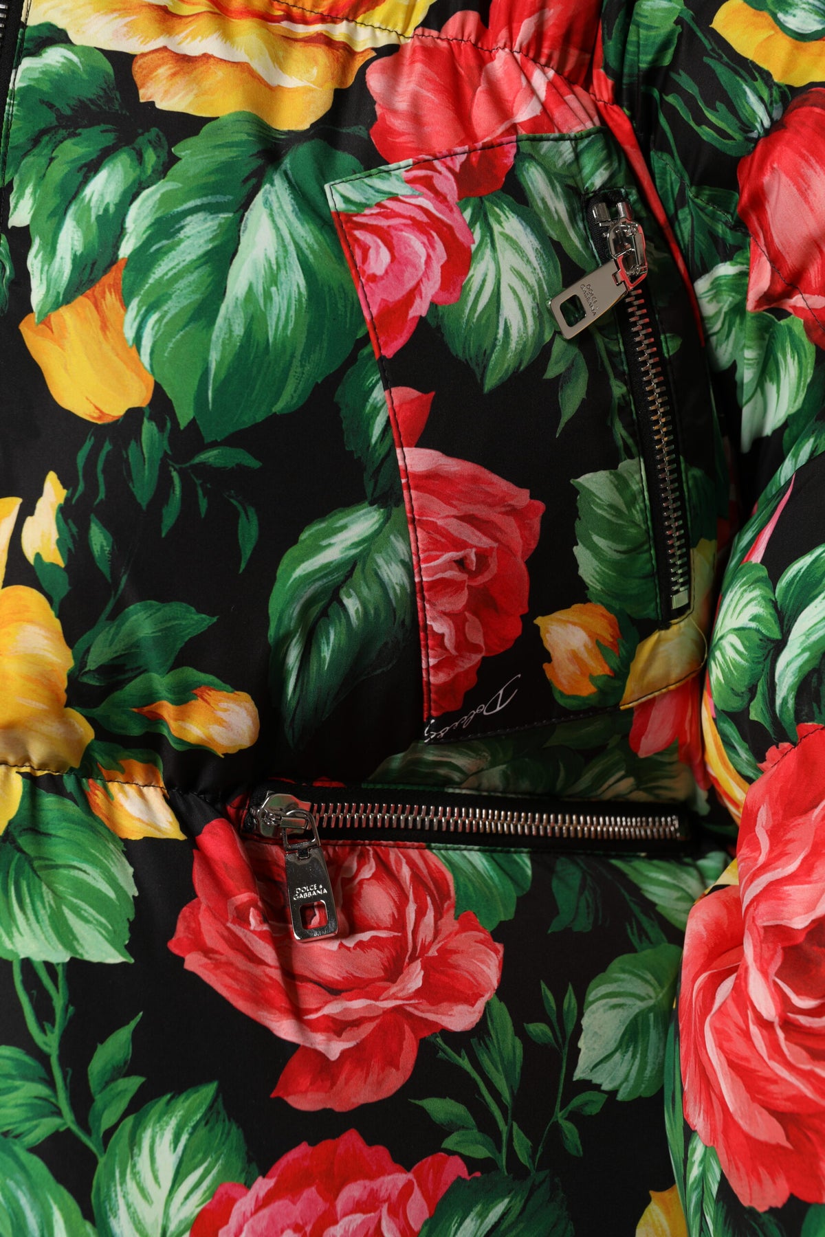 Indulge in the Dolce & Gabbana Multicolor Floral Puffer Hooded Jacket, a masterpiece of Italian craftsmanship that elevates your style with luxurious comfort and vibrant elegance.