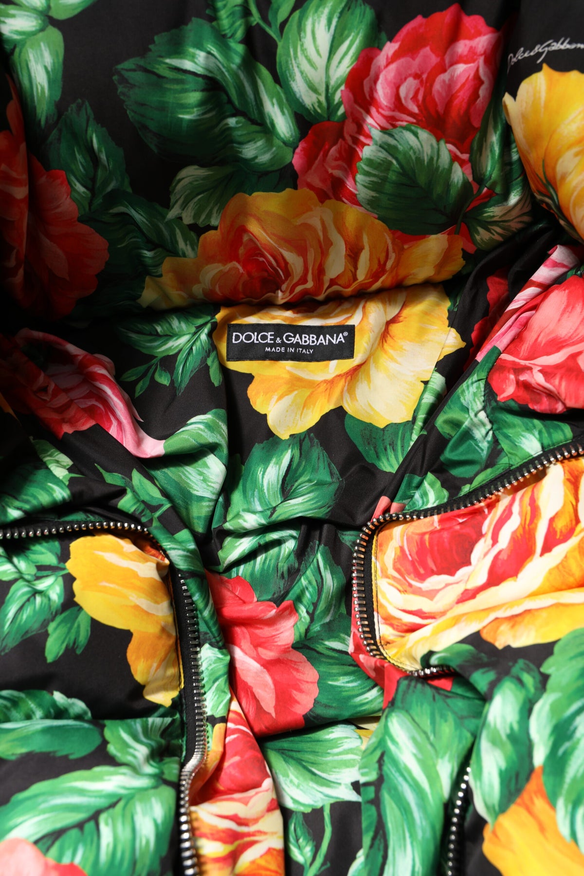 Indulge in the Dolce & Gabbana Multicolor Floral Puffer Hooded Jacket, a masterpiece of Italian craftsmanship, blending luxurious comfort with vibrant elegance for every occasion.