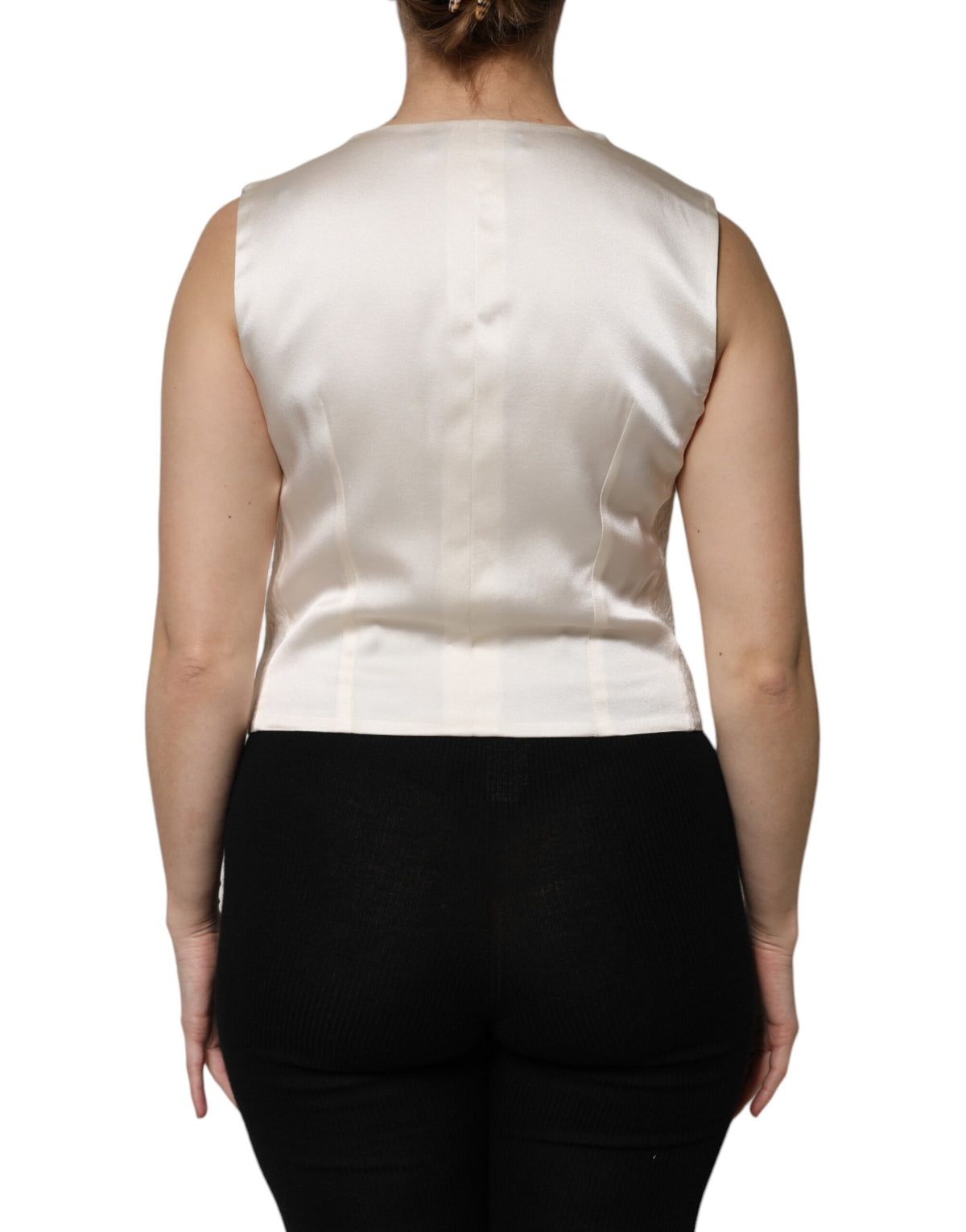 Indulge in the elegance of the Dolce & Gabbana Ivory Cotton Button Down Sleeveless Vest Top, crafted in Italy from luxurious materials for a timeless allure.
