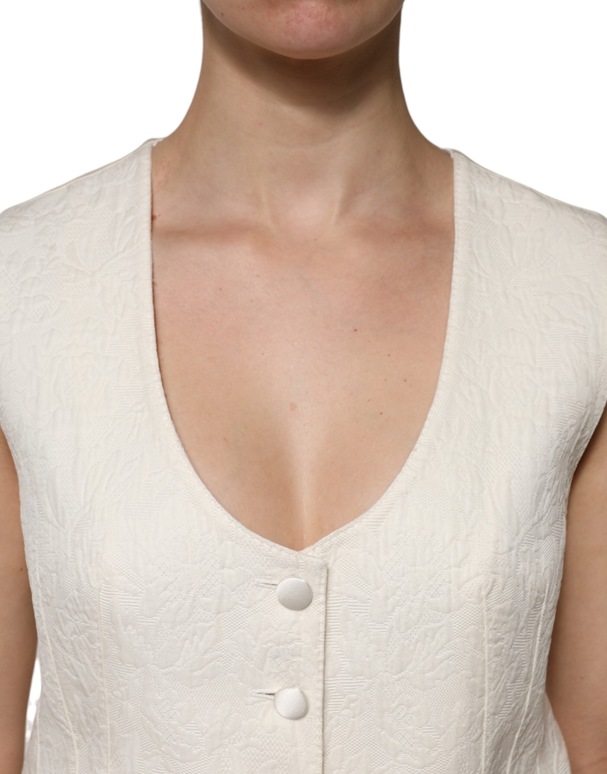 Indulge in the exquisite Dolce & Gabbana Ivory Cotton Button Down Sleeveless Vest Top, a masterpiece of Italian craftsmanship blending luxury cotton and silk for timeless elegance.