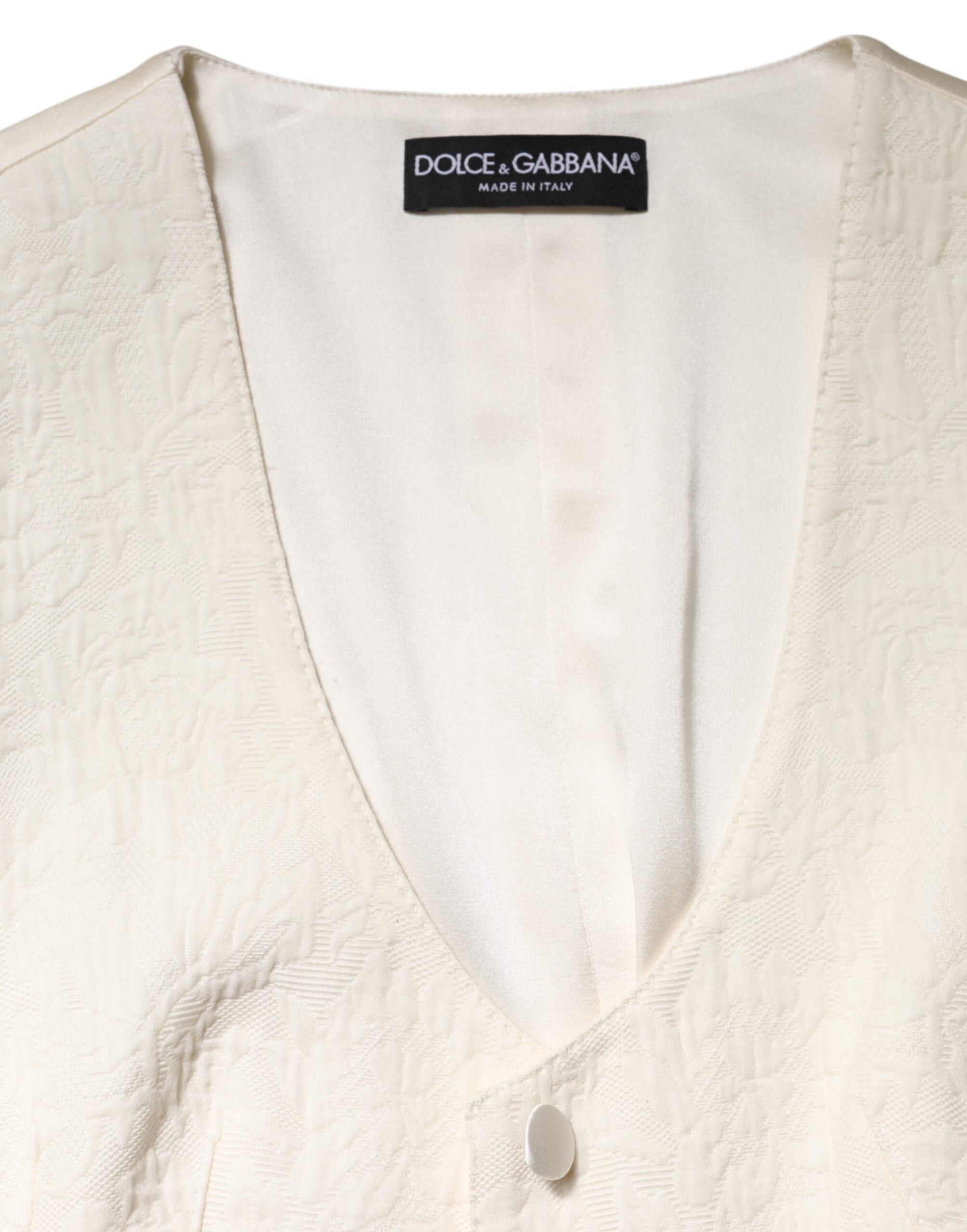 Indulge in the exquisite Dolce & Gabbana Ivory Cotton Button Down Sleeveless Vest Top, a masterpiece of Italian craftsmanship blending luxury materials for timeless elegance.