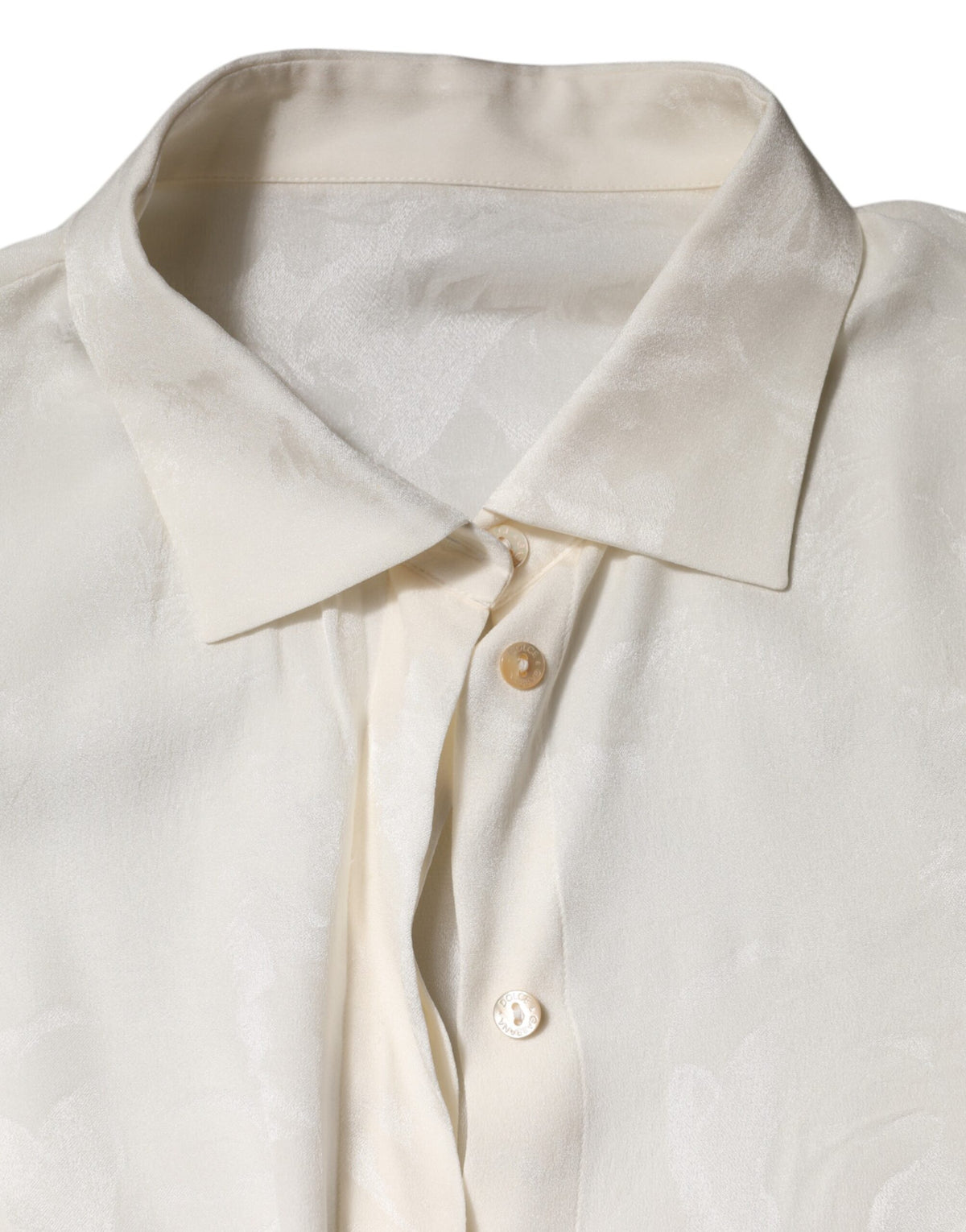 Indulge in the exquisite Dolce & Gabbana White Button Down Long Sleeves Blouse, a silk masterpiece that embodies timeless elegance and sophisticated allure.