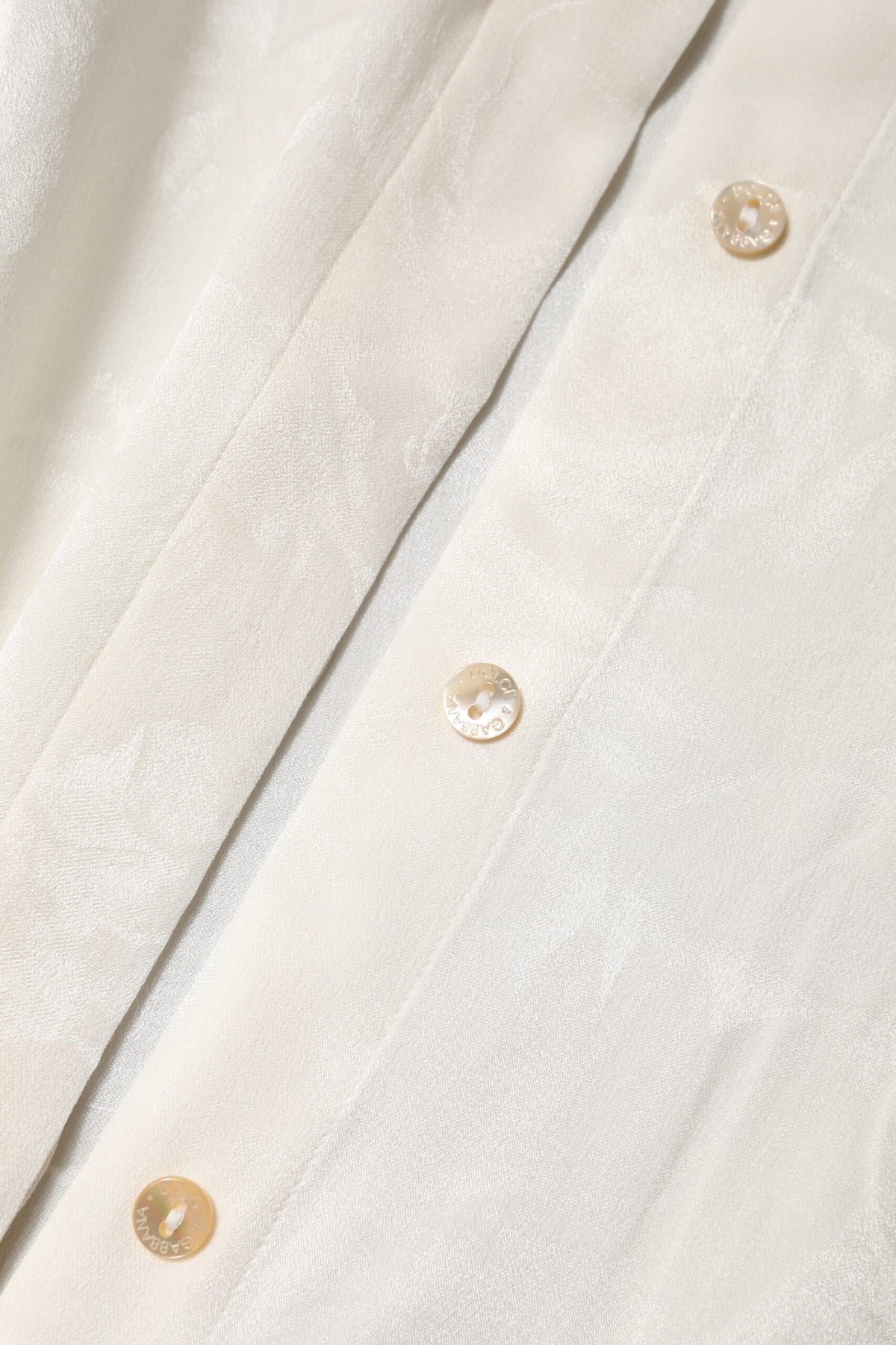 Indulge in the exquisite Dolce & Gabbana White Button Down Long Sleeves Blouse Top, a silk masterpiece that embodies timeless elegance and luxurious craftsmanship.