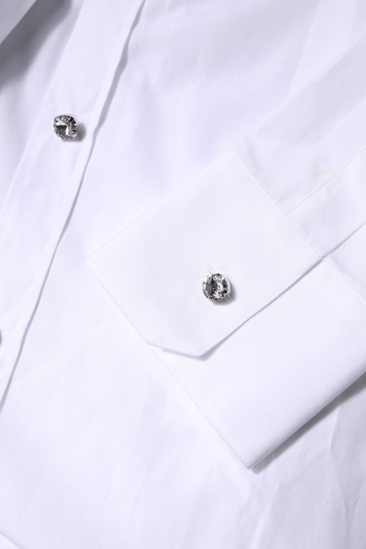 Elevate your wardrobe with the Dolce & Gabbana White Rhinestone Embellish Long Sleeves Top, a luxurious cotton masterpiece that embodies elegance and sophistication.