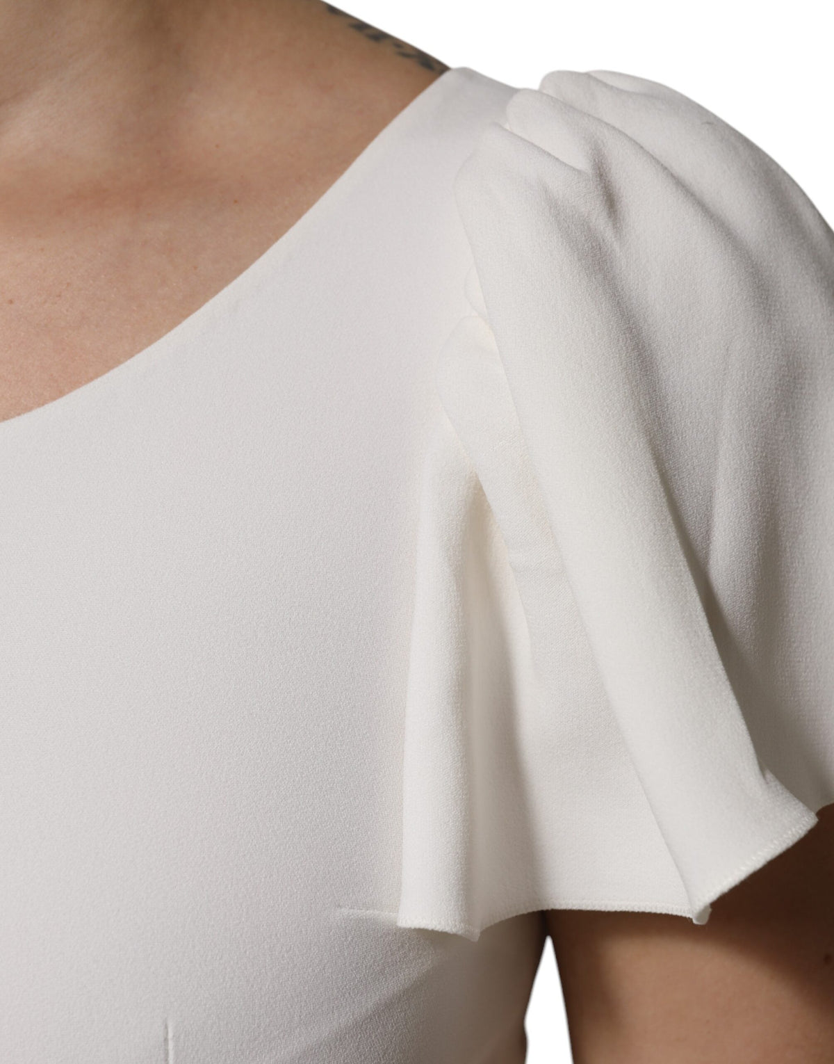 Elevate your wardrobe with the Dolce & Gabbana White Viscose Round Neck Top, a masterpiece of Italian craftsmanship that embodies timeless elegance and versatile luxury.